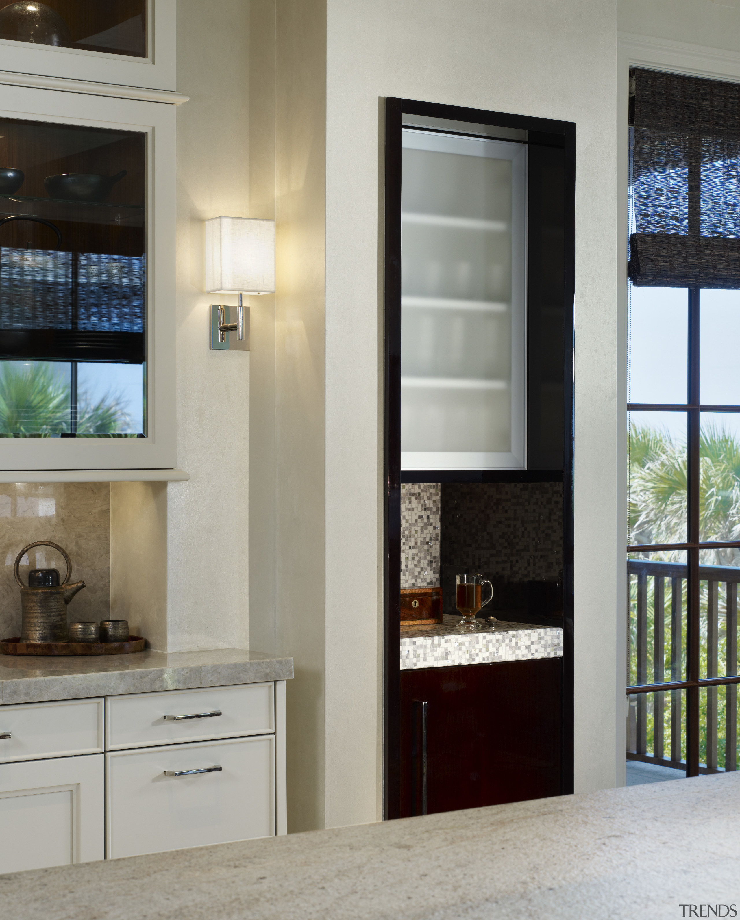 View of a kitchen featuring wine cooler, with cabinetry, home appliance, interior design, window, gray