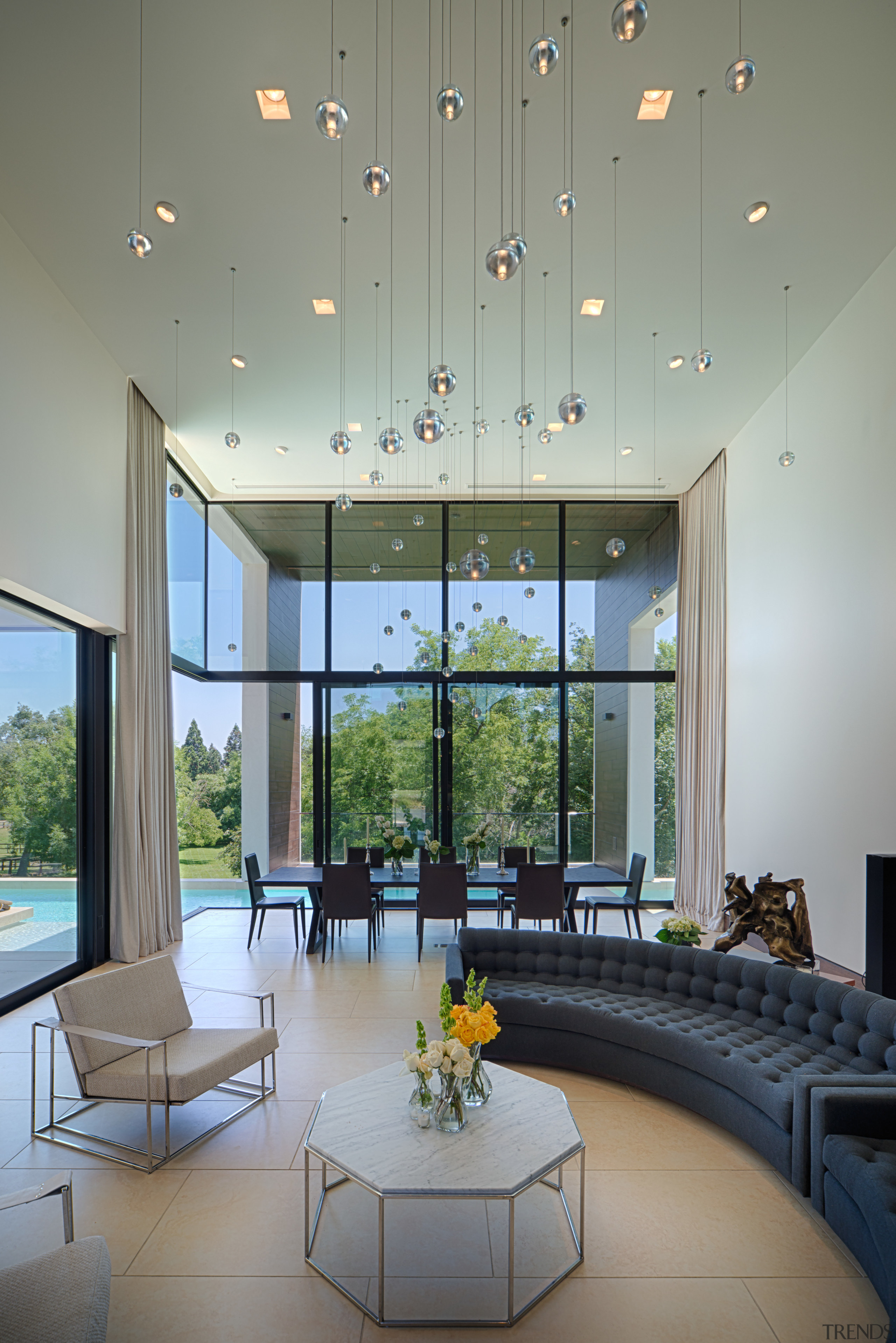 The entry leads directly into a large, two-story architecture, ceiling, daylighting, house, interior design, living room, lobby, window, gray