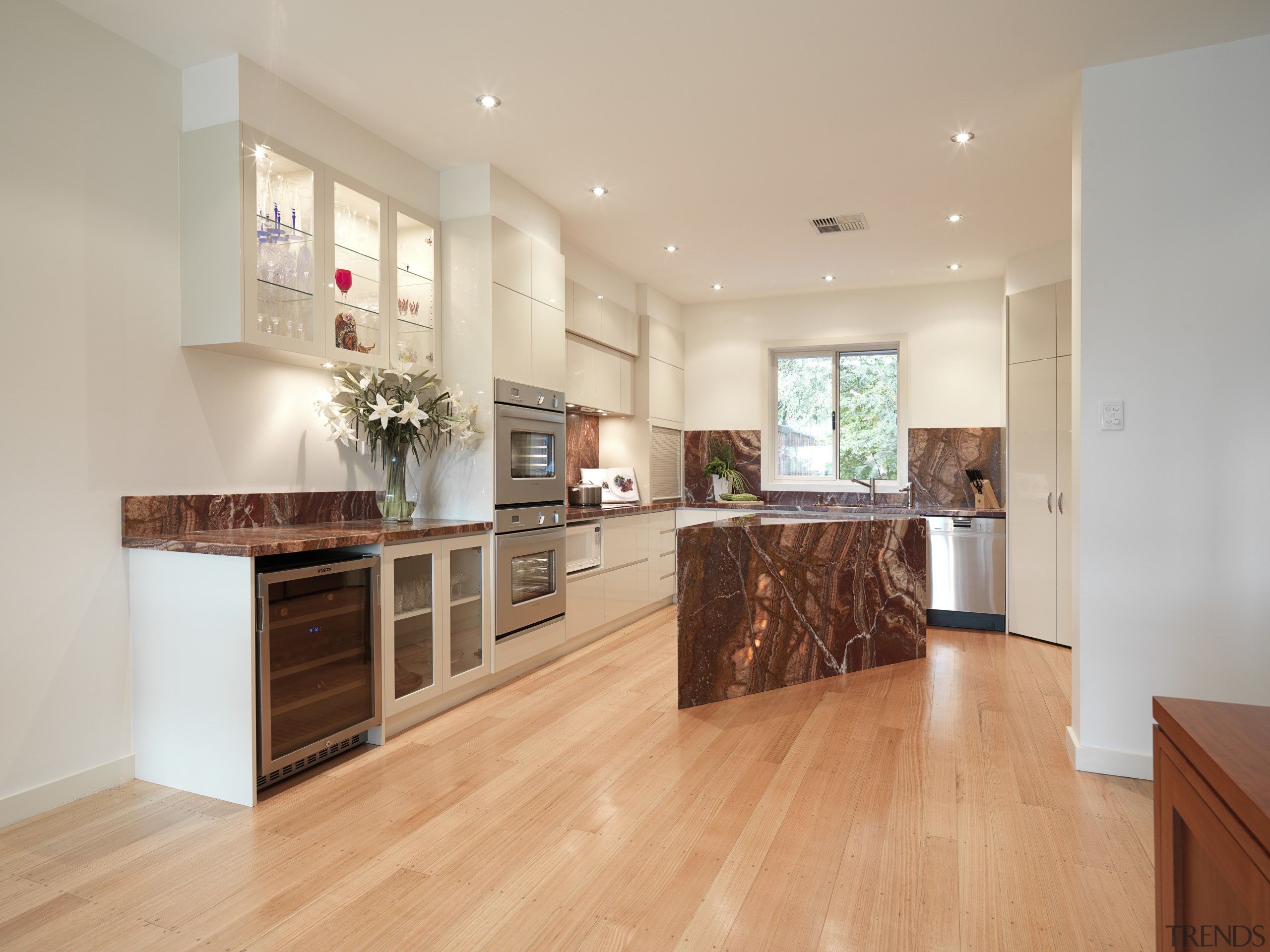 View of contemporary kitchen with light wooden flooring, cabinetry, countertop, cuisine classique, floor, flooring, hardwood, interior design, kitchen, laminate flooring, property, real estate, room, wood, wood flooring, gray, orange