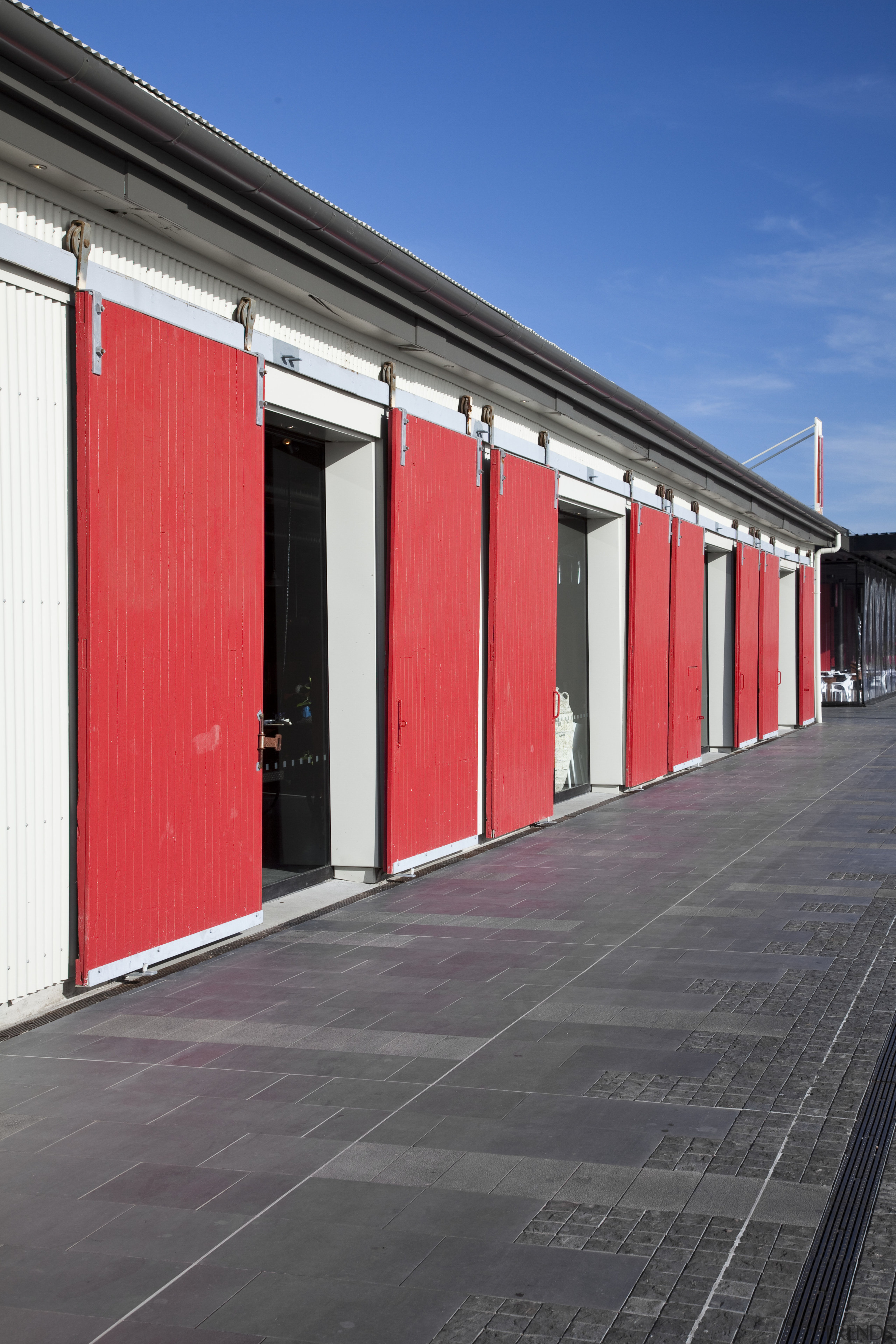 External view of a building in Wynyard Quater architecture, building, door, facade, house, infrastructure, line, metropolitan area, red, sky, structure, window, gray