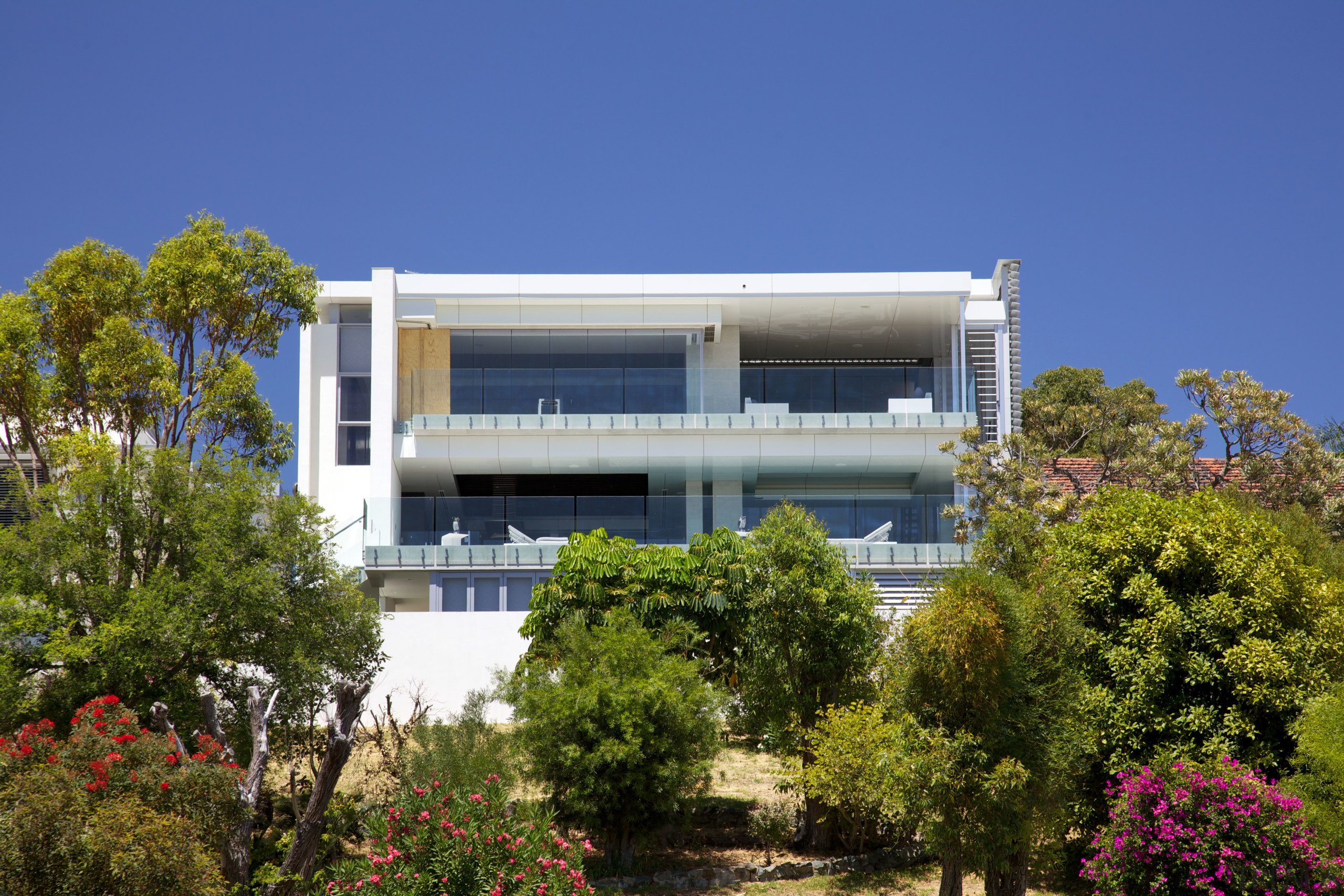 This new house by architect Anthony Rechichi steps apartment, architecture, building, condominium, corporate headquarters, daytime, facade, home, house, mixed use, plant, property, real estate, residential area, sky, tree, villa, blue, brown