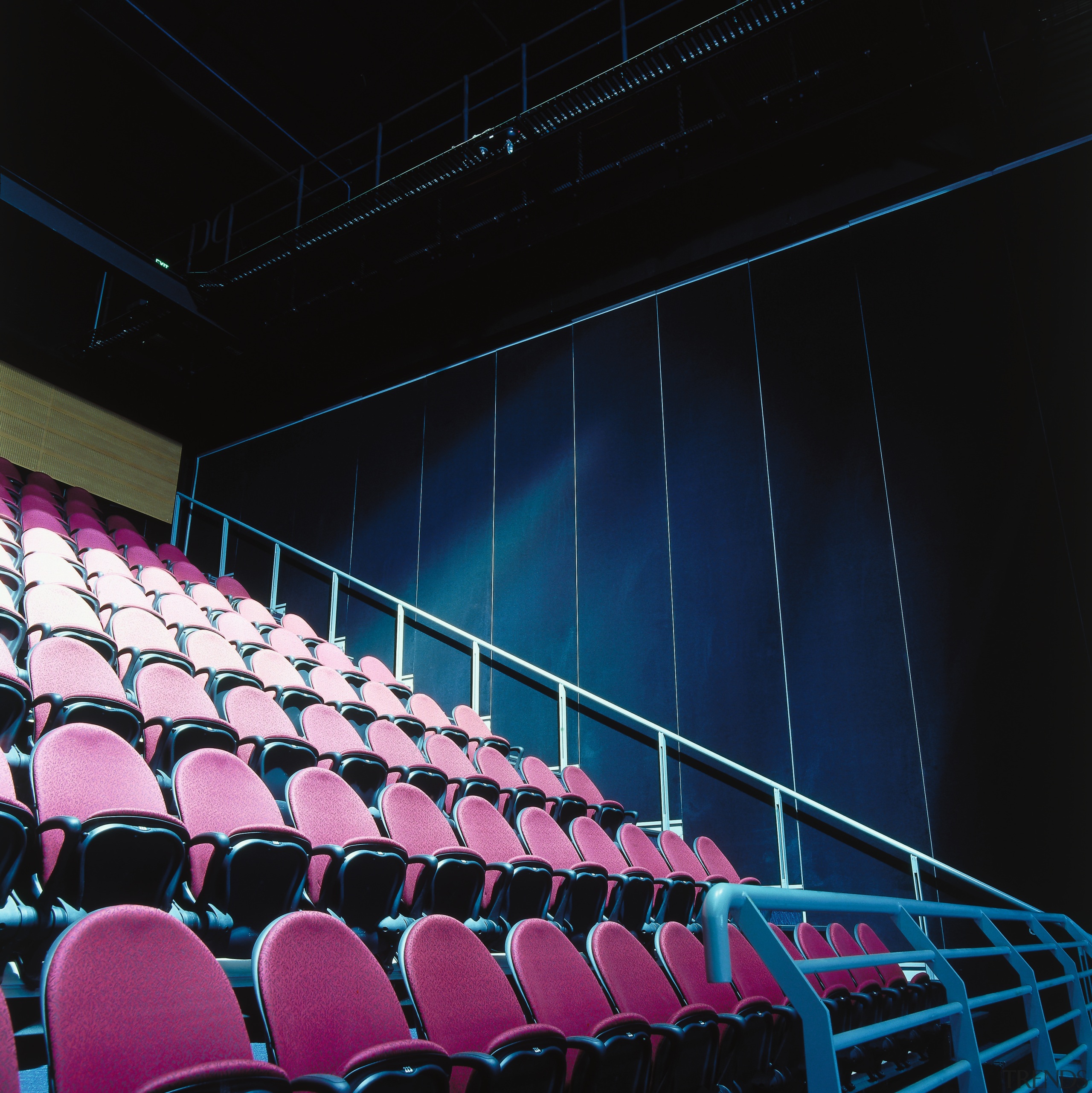 Arena seating area with pink terraced seating, and architecture, auditorium, light, lighting, line, movie theater, performing arts center, purple, sport venue, stage, structure, theatre, black