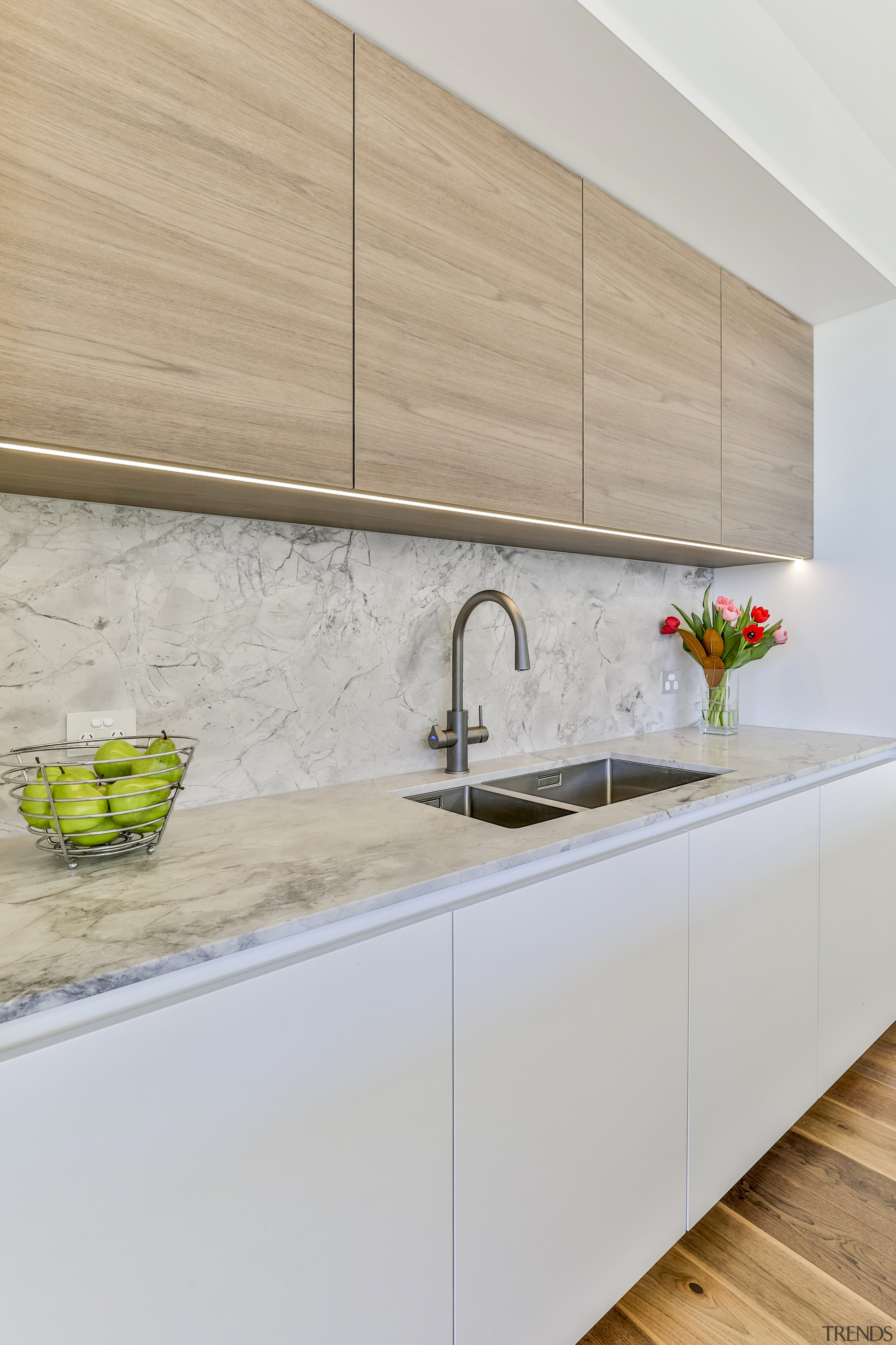 Recessed LED strips accentuate the handless perimeter cabinetry. 