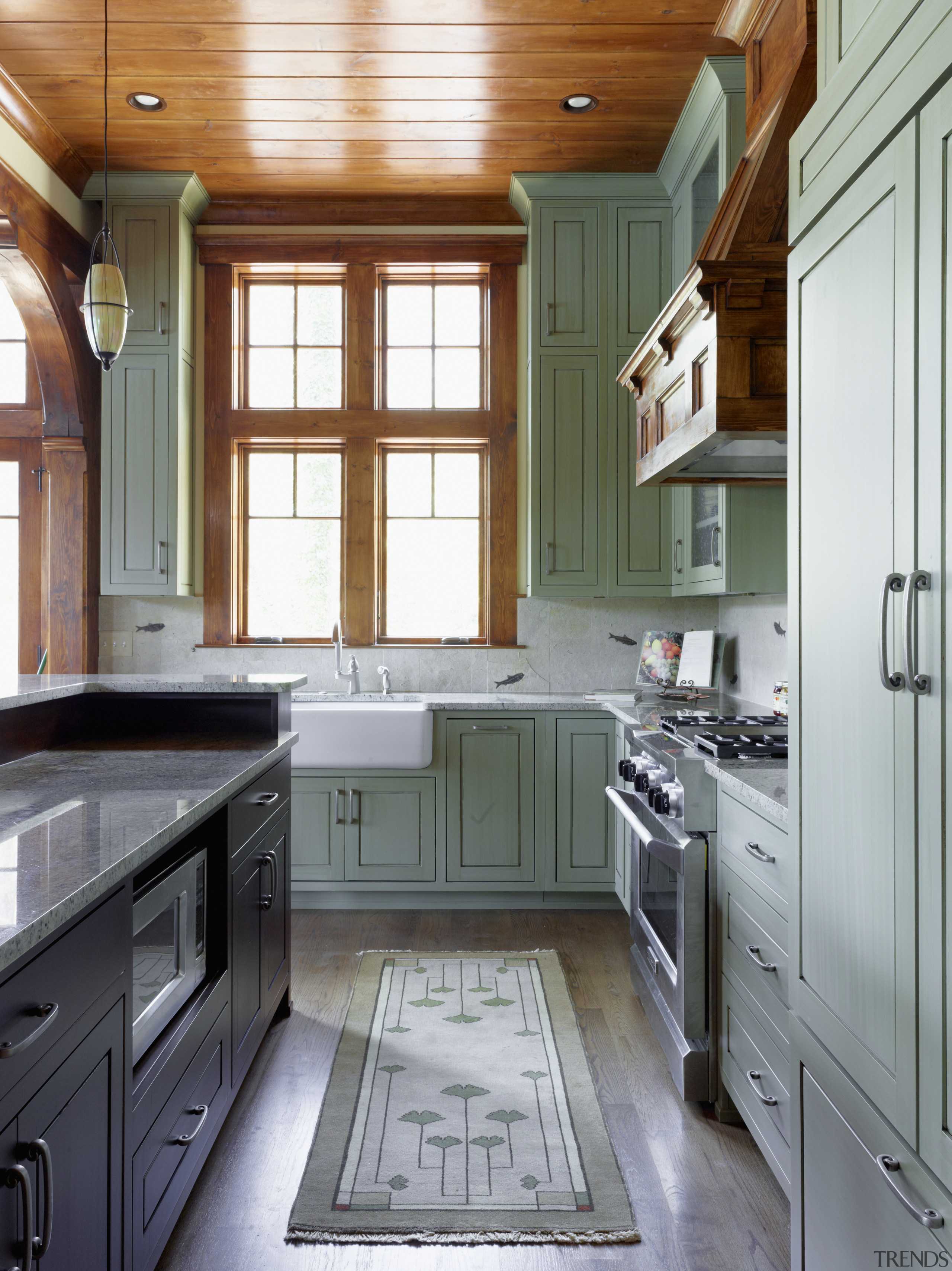 This lakefront house was remodeled to reference the cabinetry, countertop, cuisine classique, floor, flooring, hardwood, home, interior design, kitchen, room, window, gray