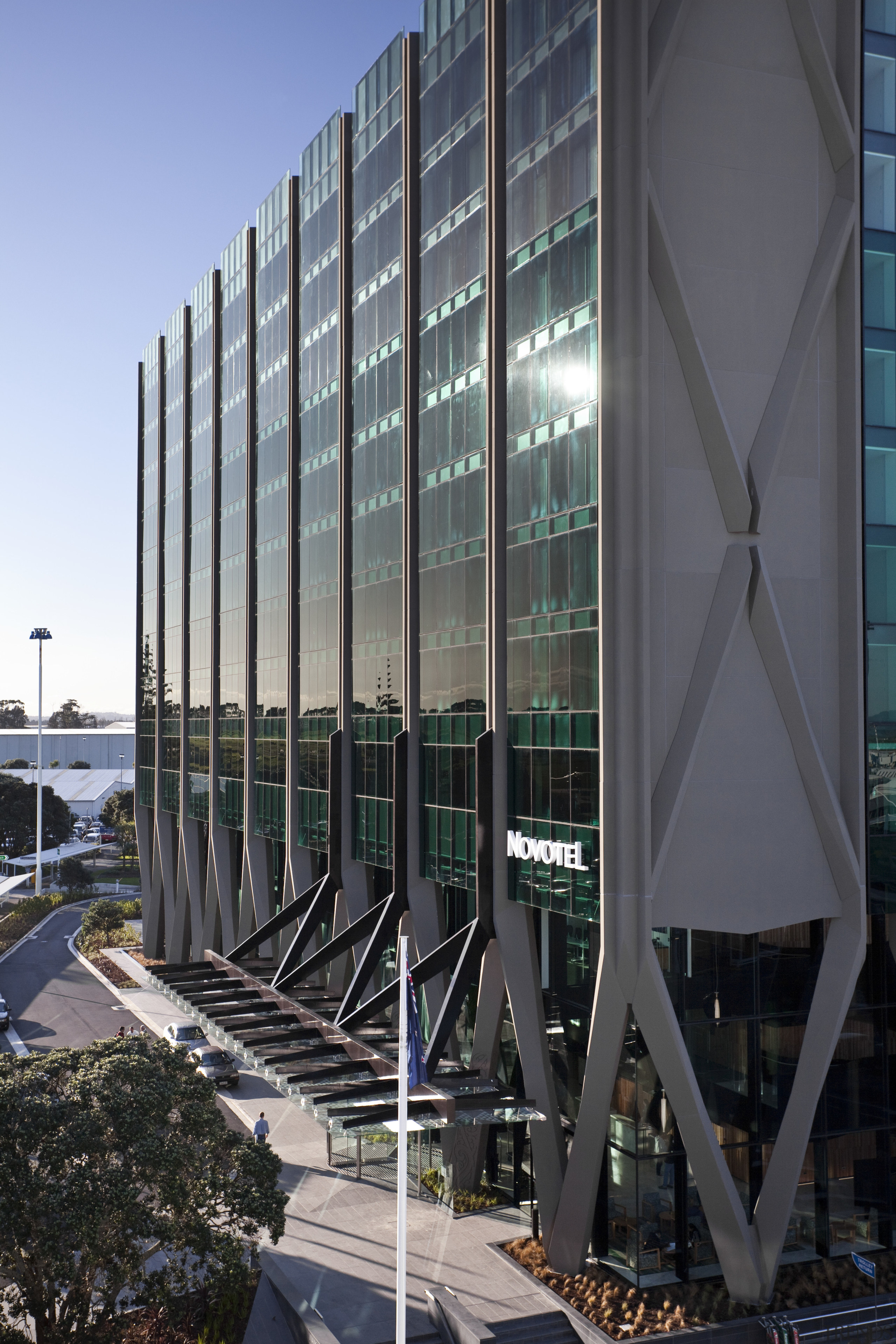 Novotel Auckland Airport by Gorge Grant Engineering. architecture, building, commercial building, condominium, corporate headquarters, daytime, facade, headquarters, metropolis, metropolitan area, mixed use, reflection, sky, skyscraper, structure, tower block, black, gray