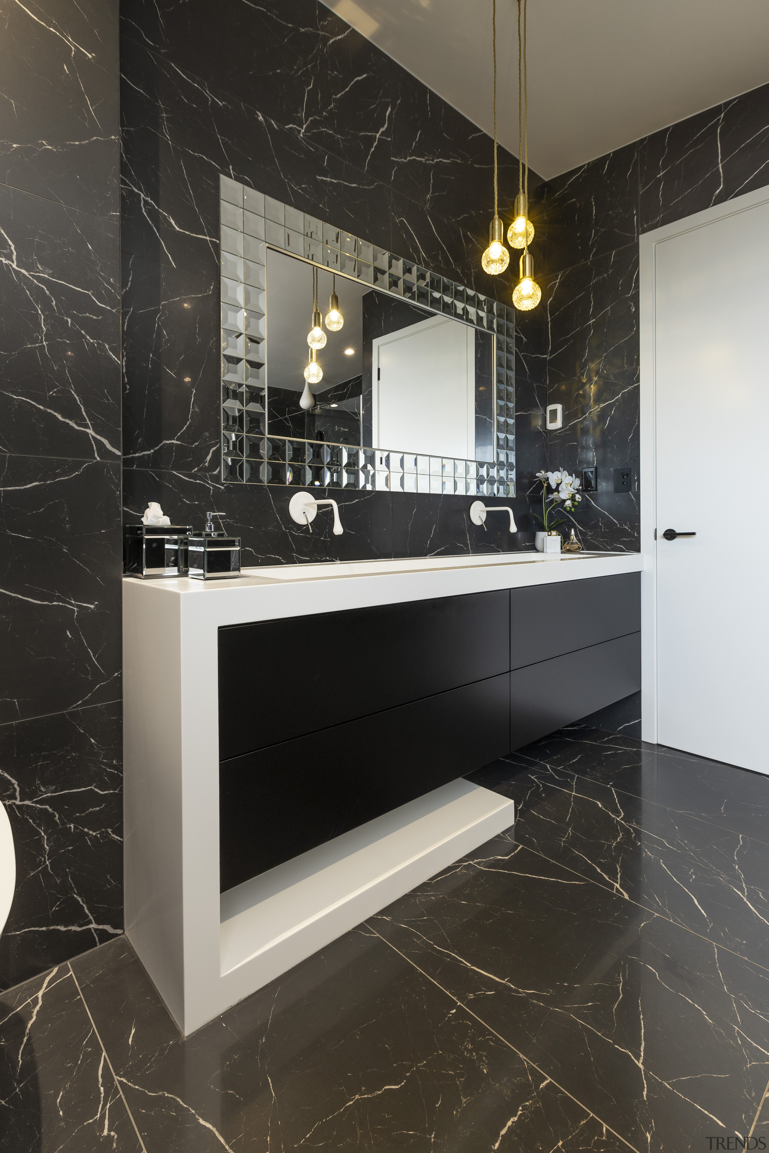 The geometric shape of the vanity in this bathroom, cabinetry, countertop, floor, flooring, furniture, interior design, room, tile, wall, black