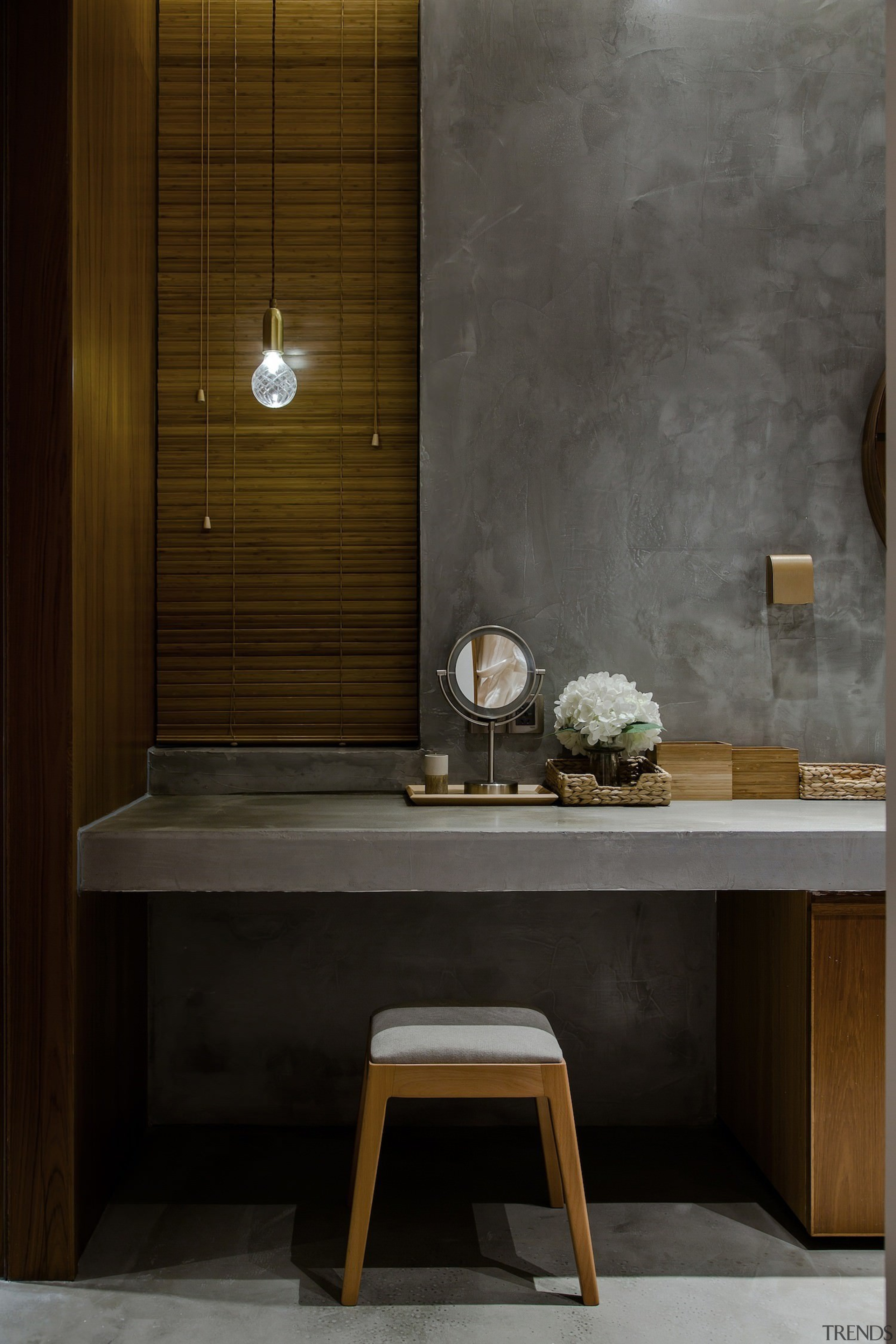 A concrete vanity is lit by a single architecture, bathroom, floor, flooring, furniture, interior design, product design, sink, tile, wall, wood, black, brown