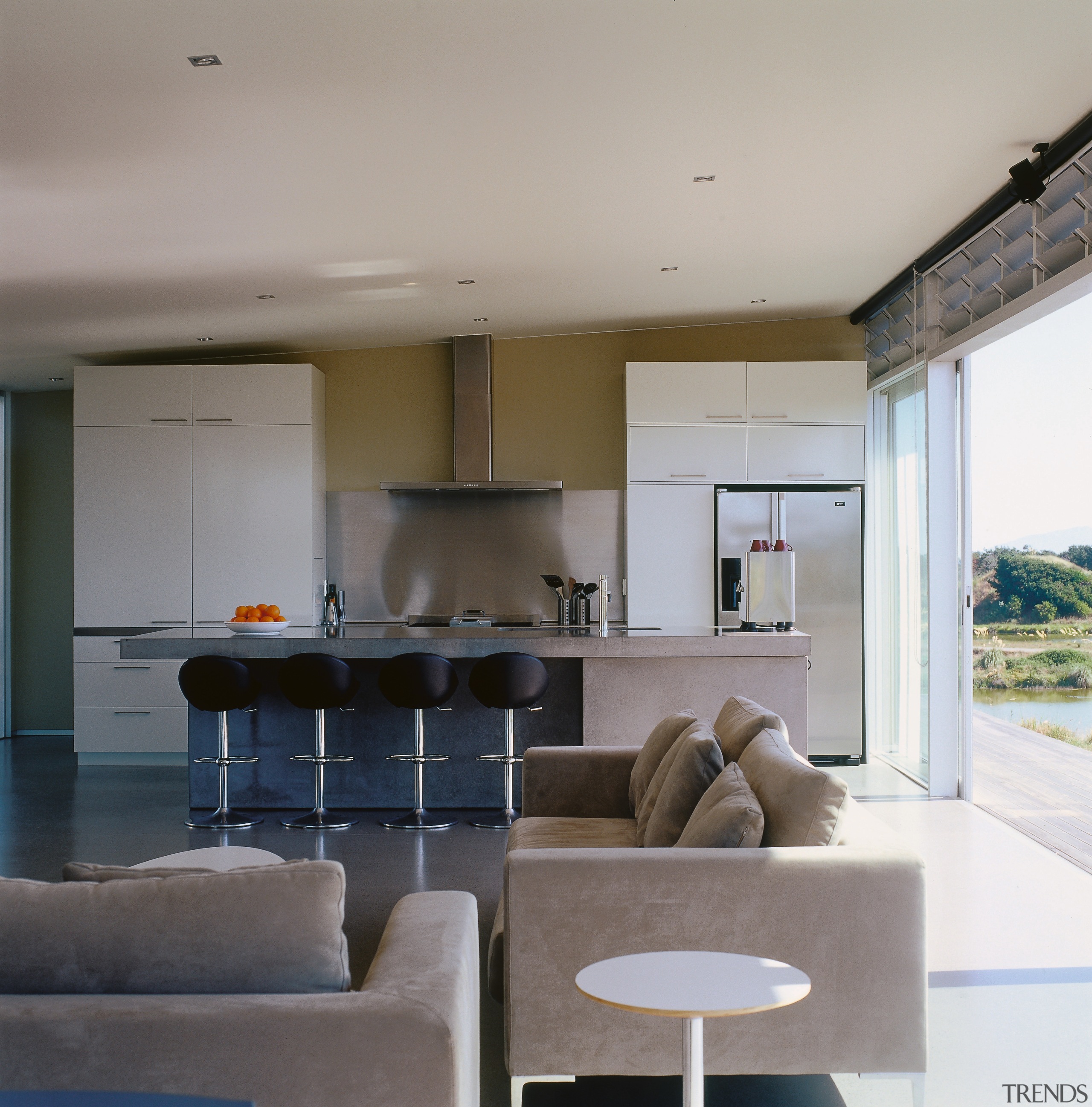 An interior view of the living area featuring architecture, ceiling, house, interior design, living room, real estate, table, gray