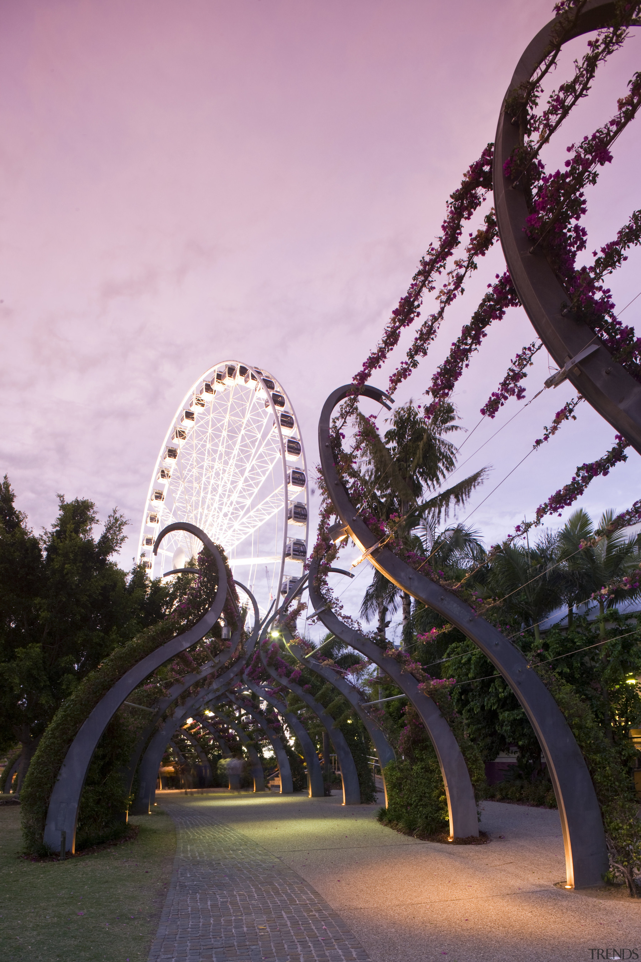 Image of a development which is part of amusement park, amusement ride, architecture, landmark, park, recreation, sky, structure, tourist attraction, tree, pink, black