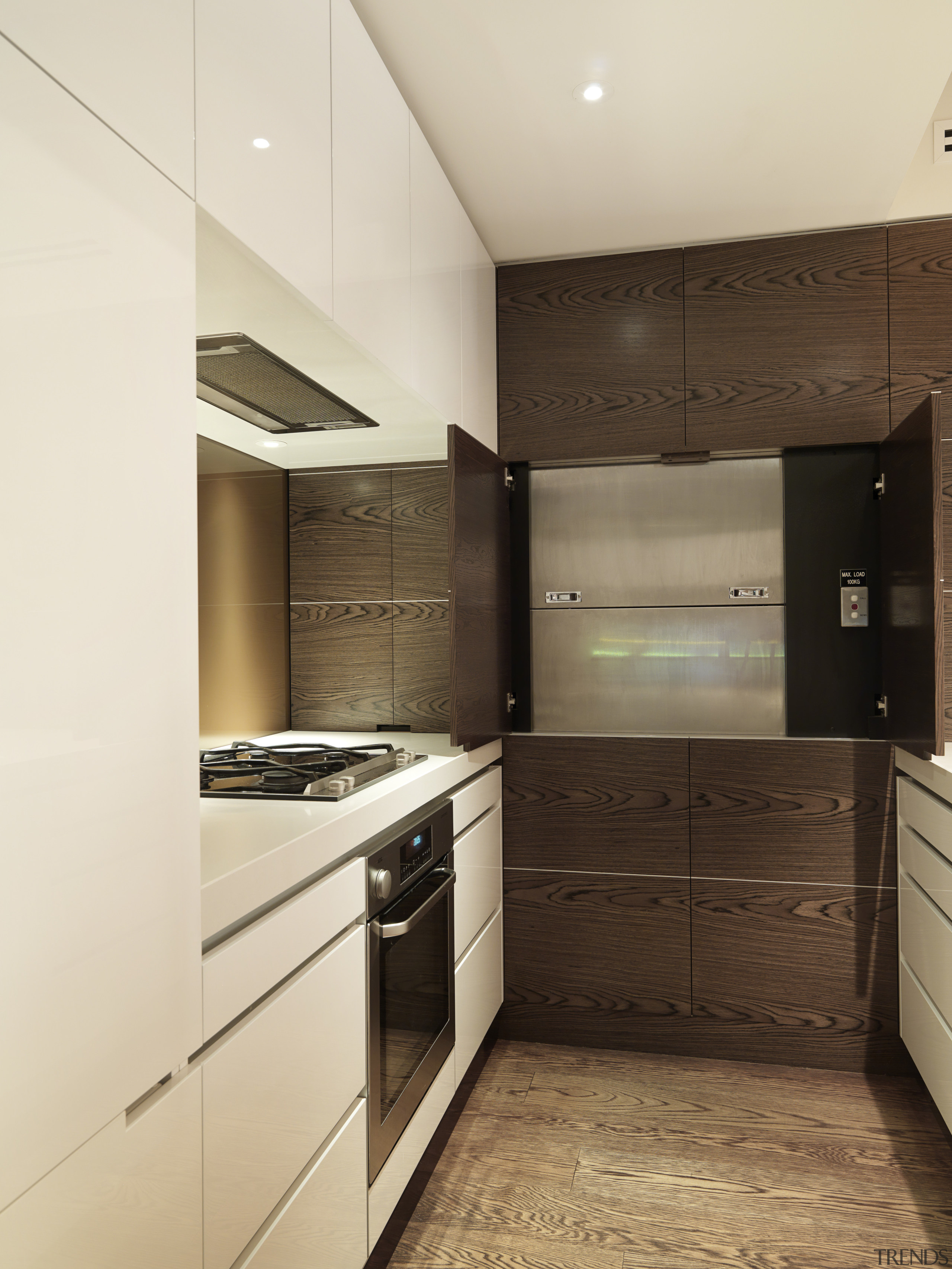 View of kitchen designed by Nicholas Murray featuring cabinetry, countertop, cuisine classique, floor, home appliance, interior design, kitchen, property, real estate, room, orange, brown