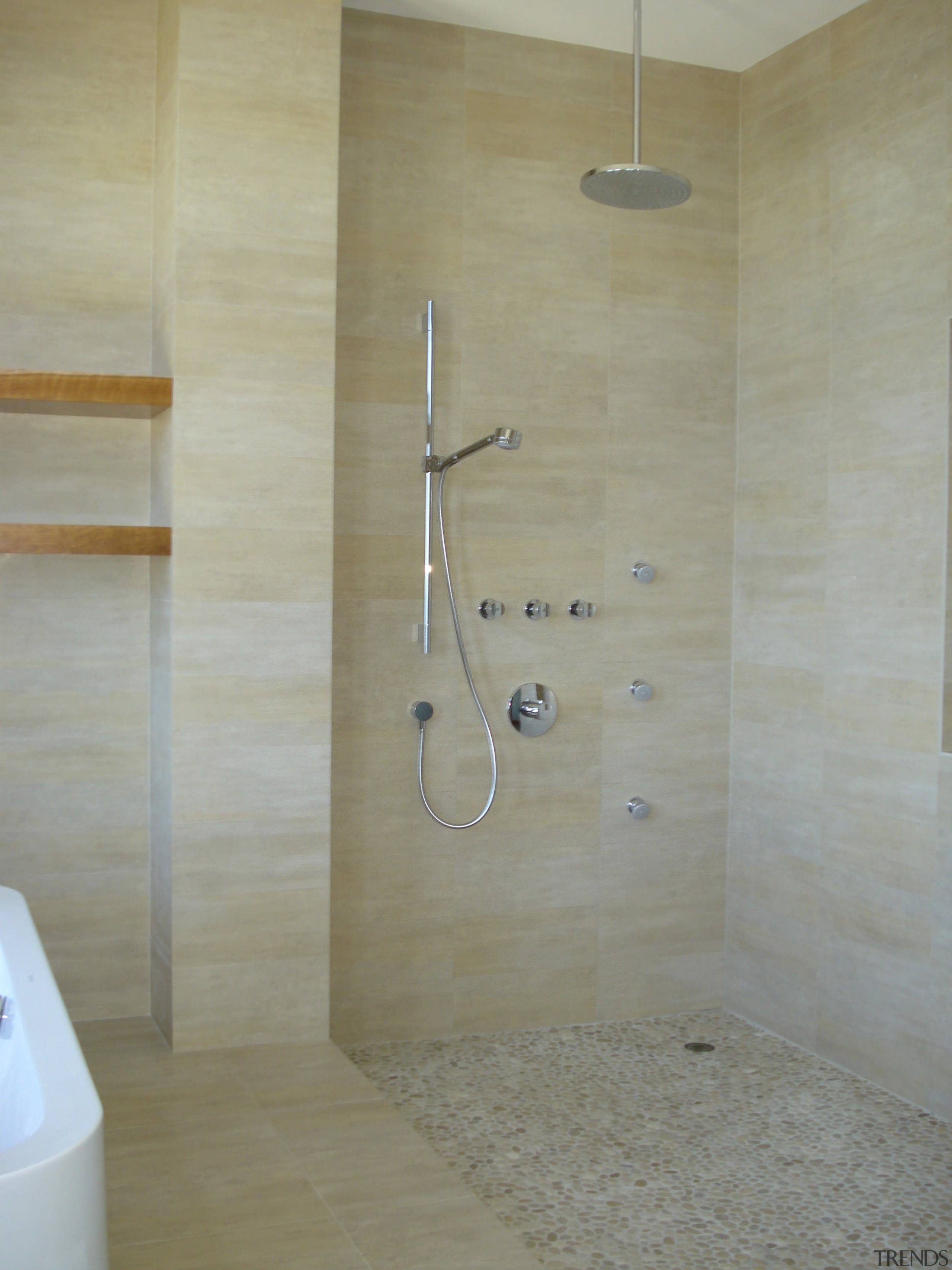 There is a distinctive Asian look to the bathroom, floor, plumbing fixture, room, shower, tile, wall, gray