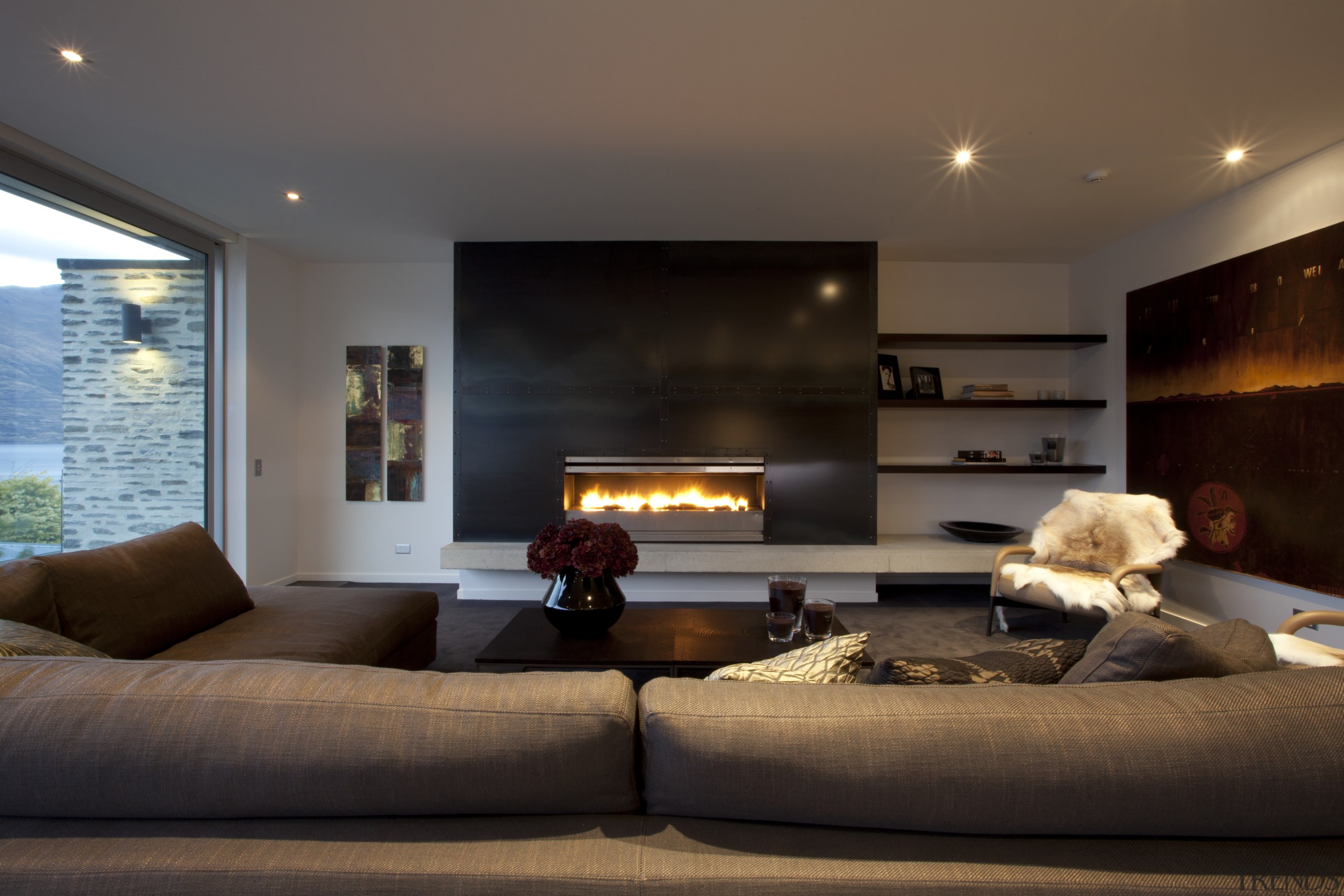 This home was designed by Allan Huntington of ceiling, fireplace, hearth, home, interior design, lighting, living room, room, black, brown