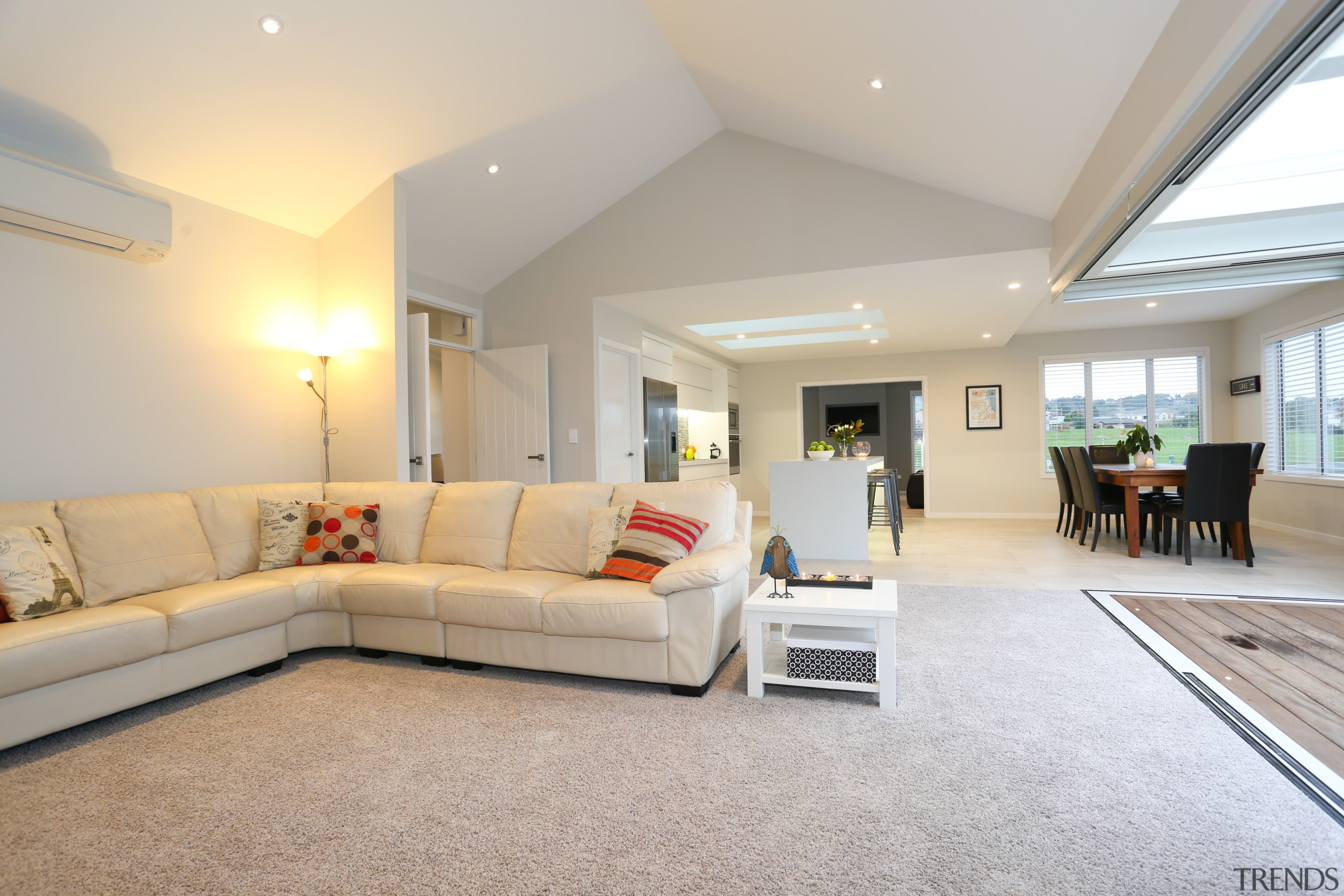 A white-on-white colour palette makes this large, open-plan ceiling, daylighting, estate, floor, flooring, home, house, interior design, living room, property, real estate, room, window, gray
