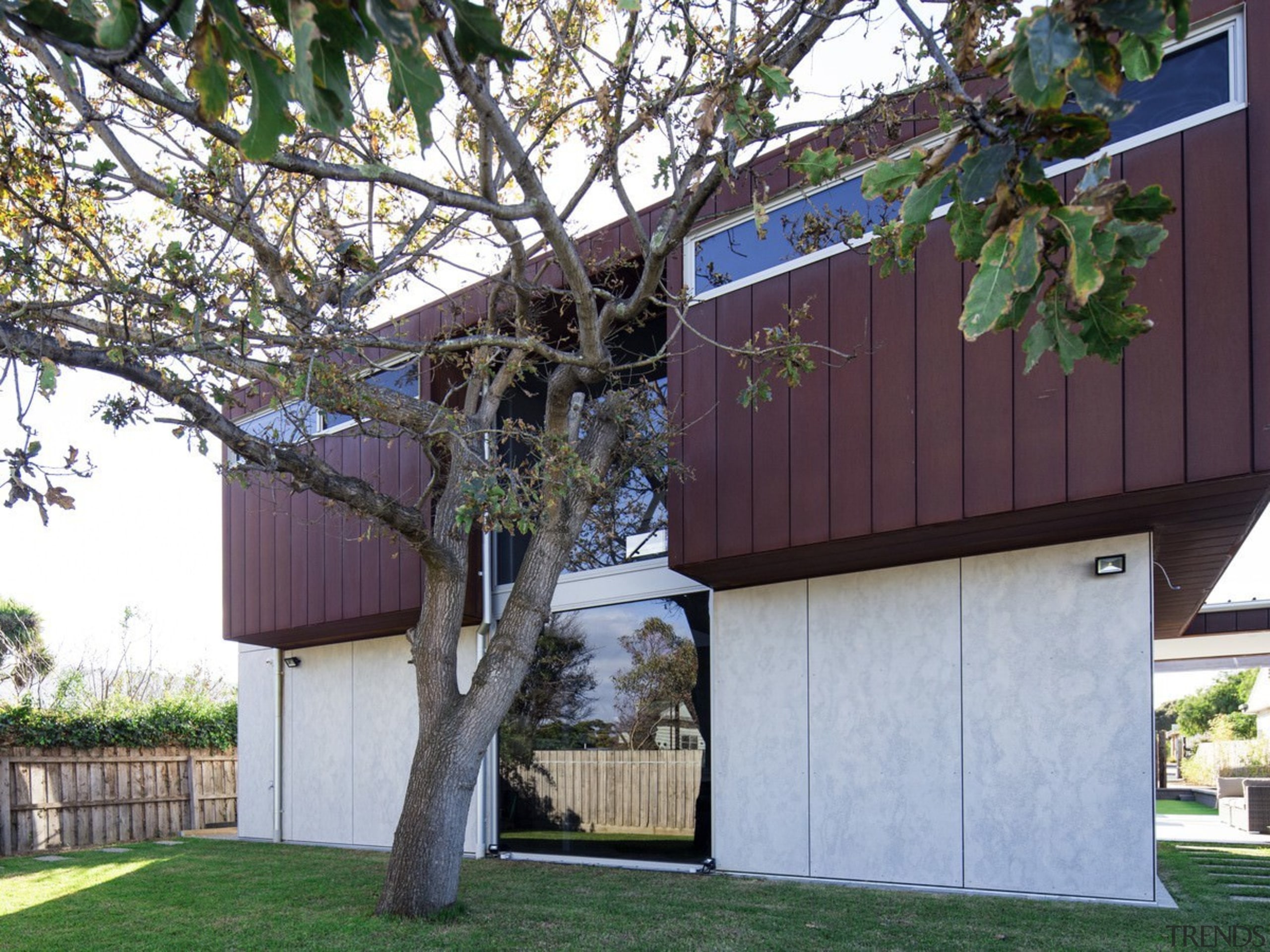 The wood has been layered on top of architecture, building, cottage, facade, home, house, outdoor structure, plant, property, real estate, residential area, shed, siding, tree, yard, gray