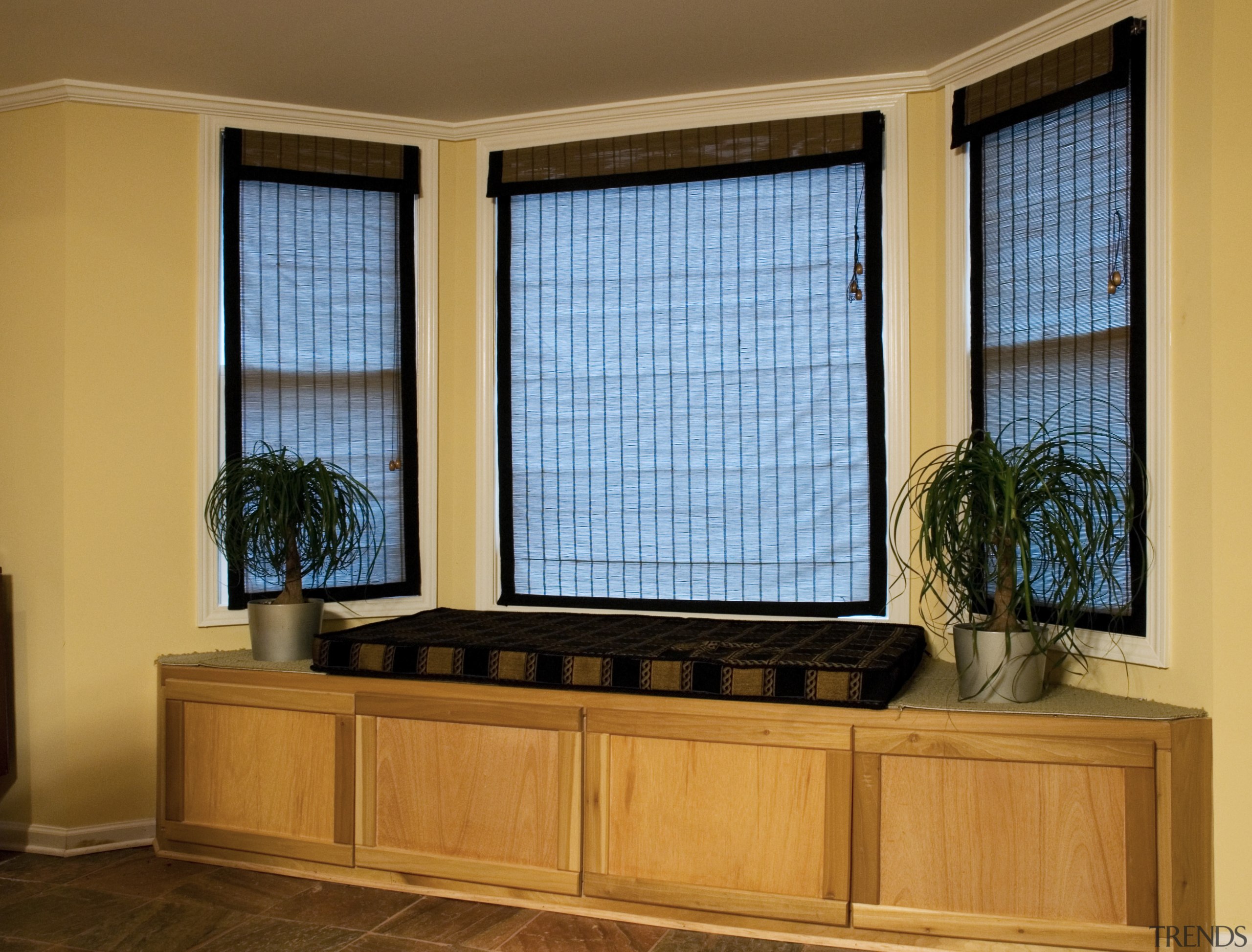 View of the bay window in the basement cabinetry, furniture, interior design, window, window blind, window covering, window treatment, orange, brown