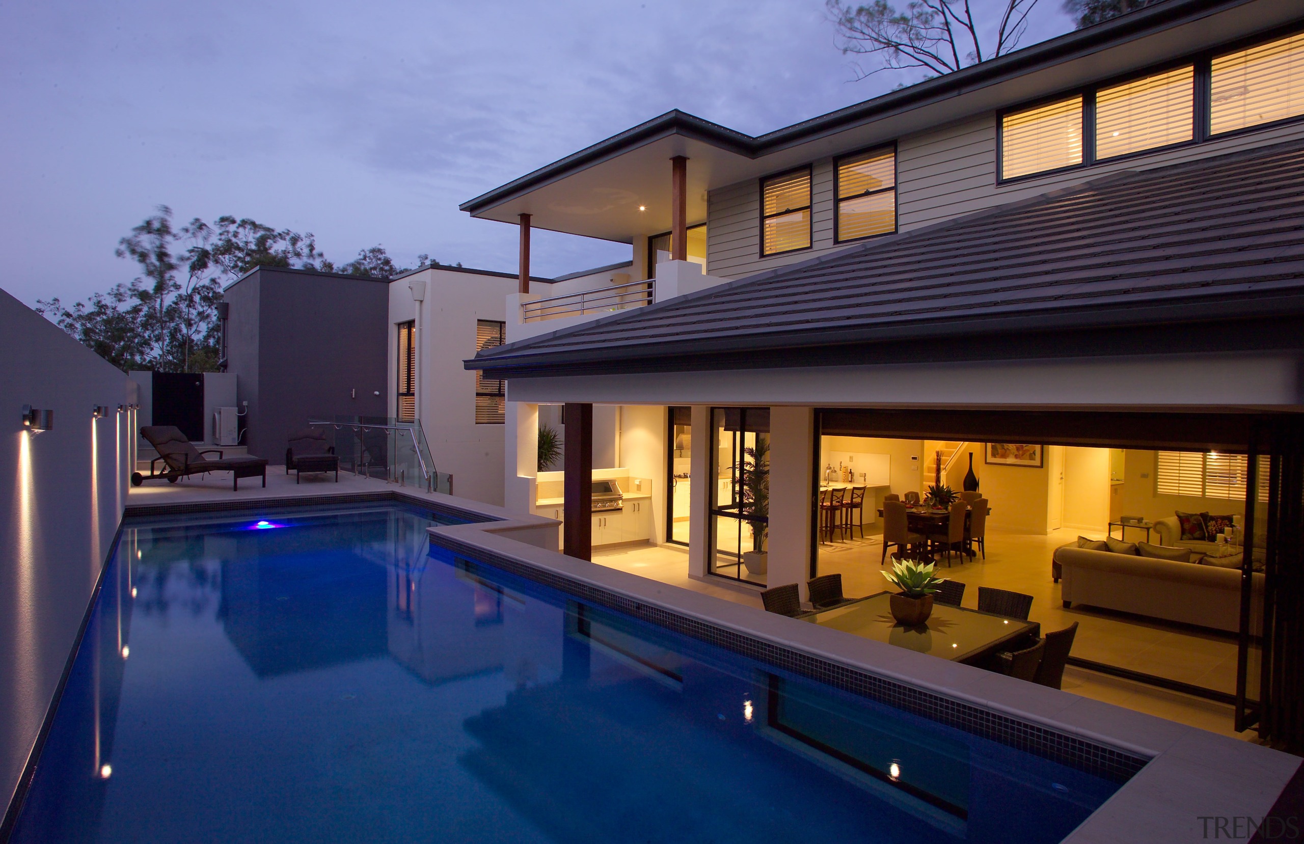 Exterior pool view of the Augusta home. Built architecture, estate, family car, home, house, lighting, property, real estate, resort, roof, swimming pool, villa, window, blue