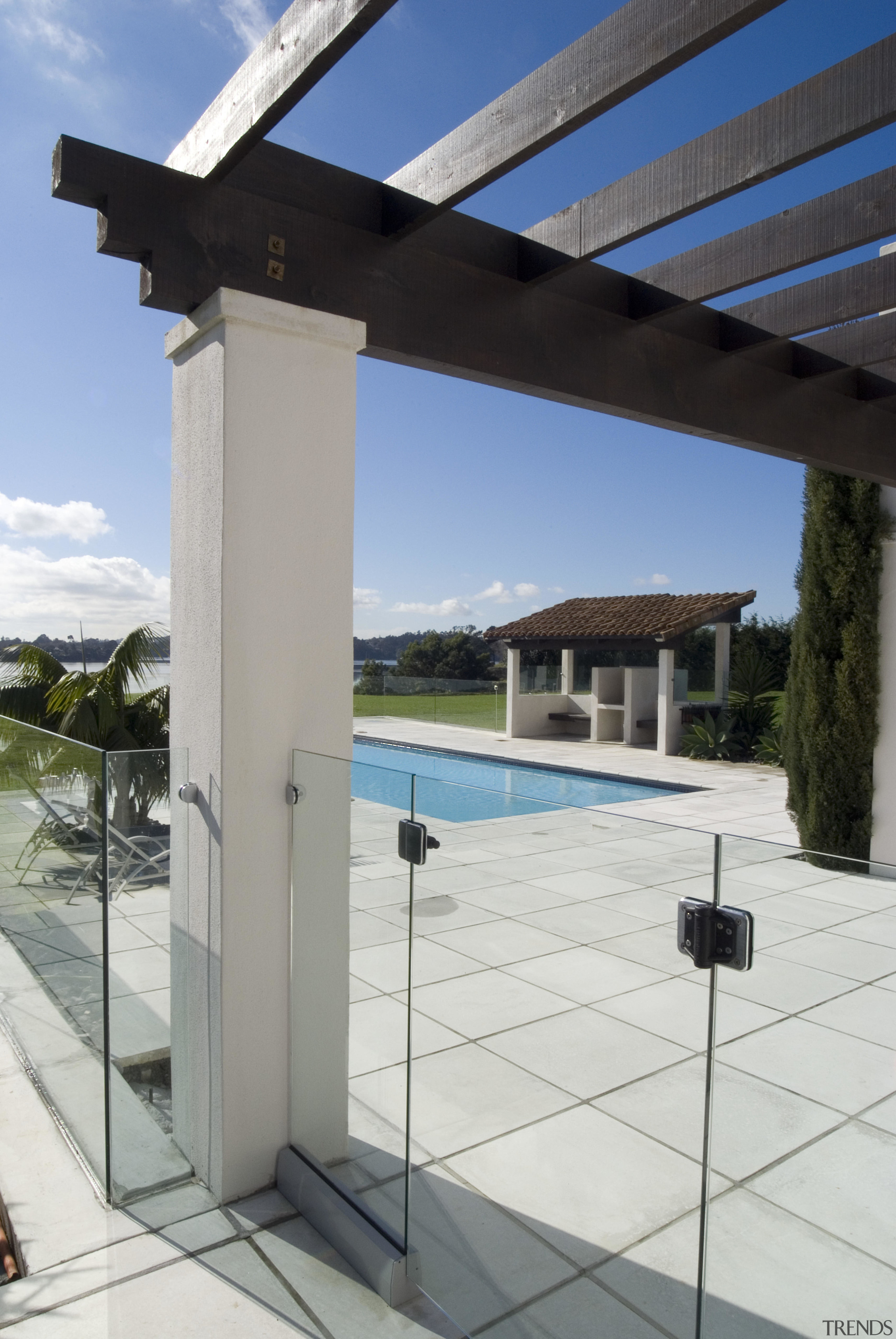 A view of this outdoor pool area featuring daylighting, glass, property, structure, window, gray, white