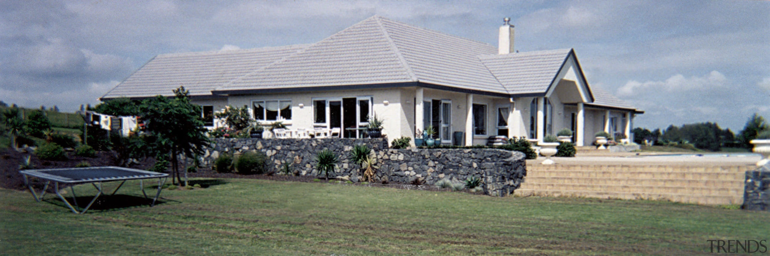 Before the renovation, the house had a more cottage, estate, farmhouse, home, house, mansion, property, real estate, roof, villa, gray