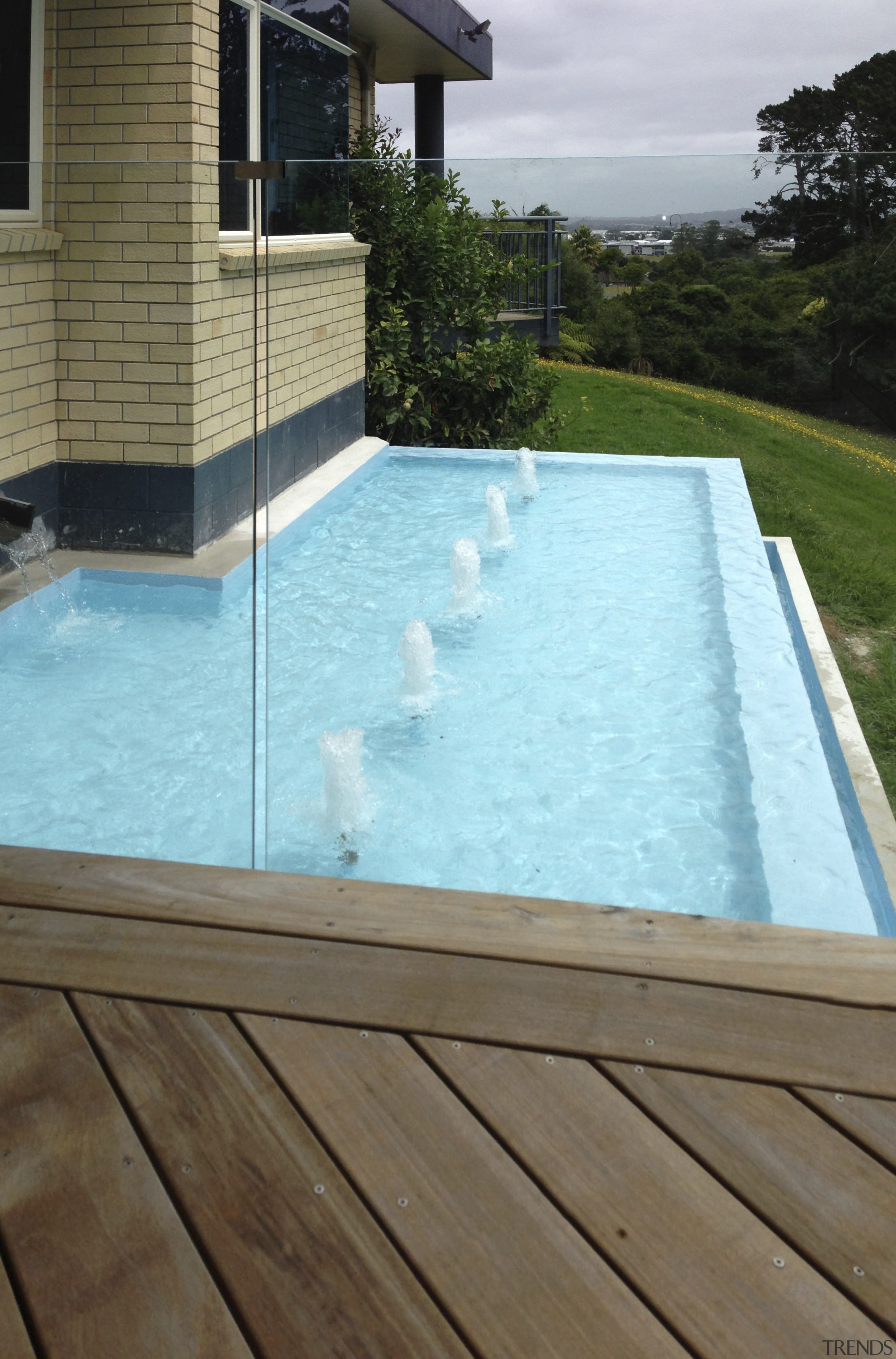 Bringing the restful sight and sound of moving backyard, daylighting, floor, house, leisure, property, real estate, swimming pool, water, water feature, brown