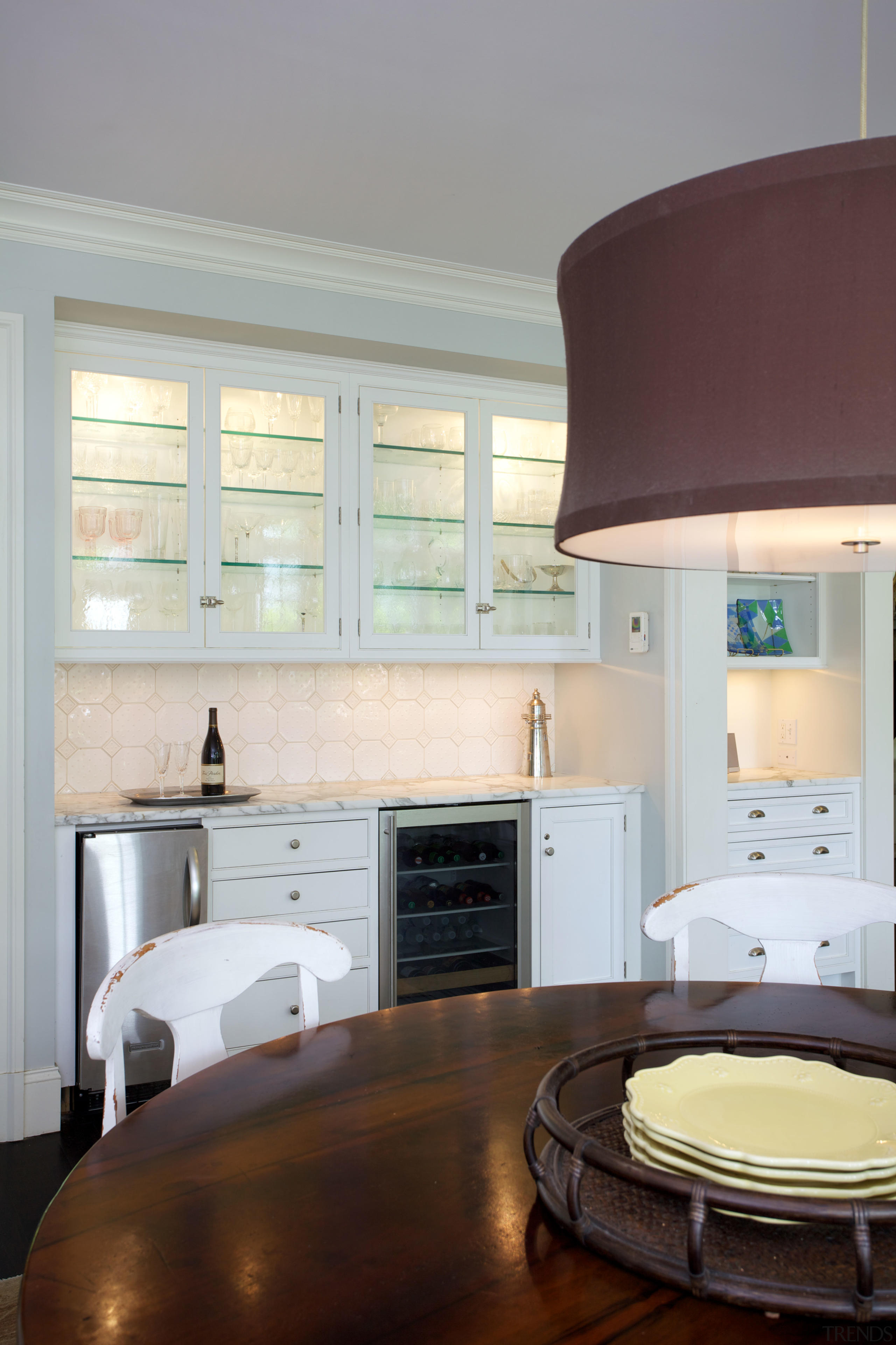 This breakfast area adjacent to the kitchen includes cabinetry, countertop, cuisine classique, floor, home, interior design, kitchen, living room, room, window, gray