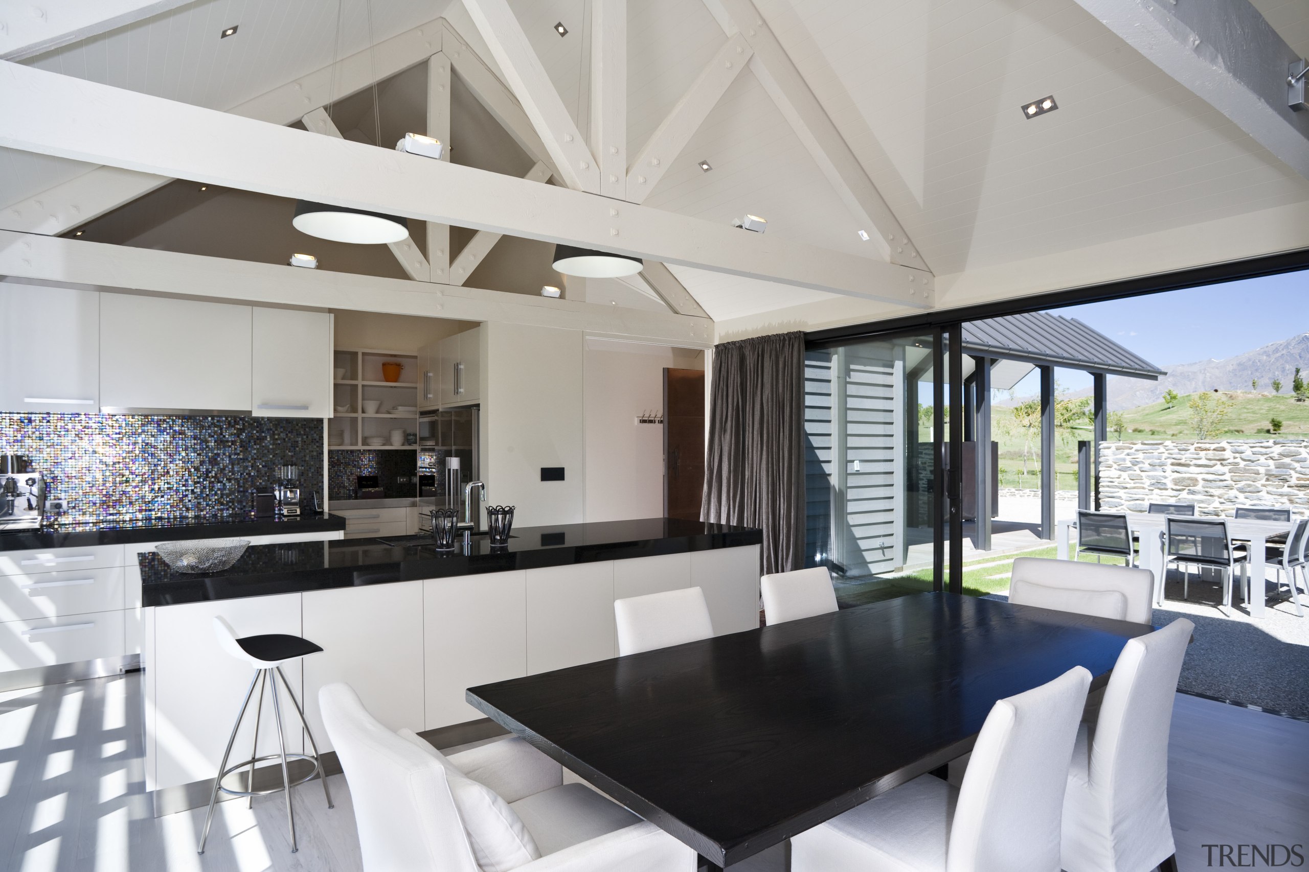 View of open-plan kitchen and dining area which architecture, ceiling, house, interior design, property, real estate, table, gray