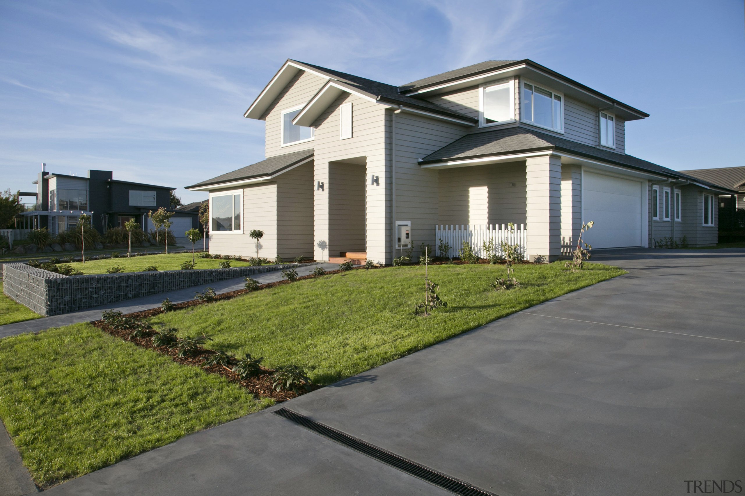 A soaring entry and multi-gabled roofline bring a elevation, estate, facade, home, house, landscape, neighbourhood, property, real estate, residential area, suburb, gray, teal