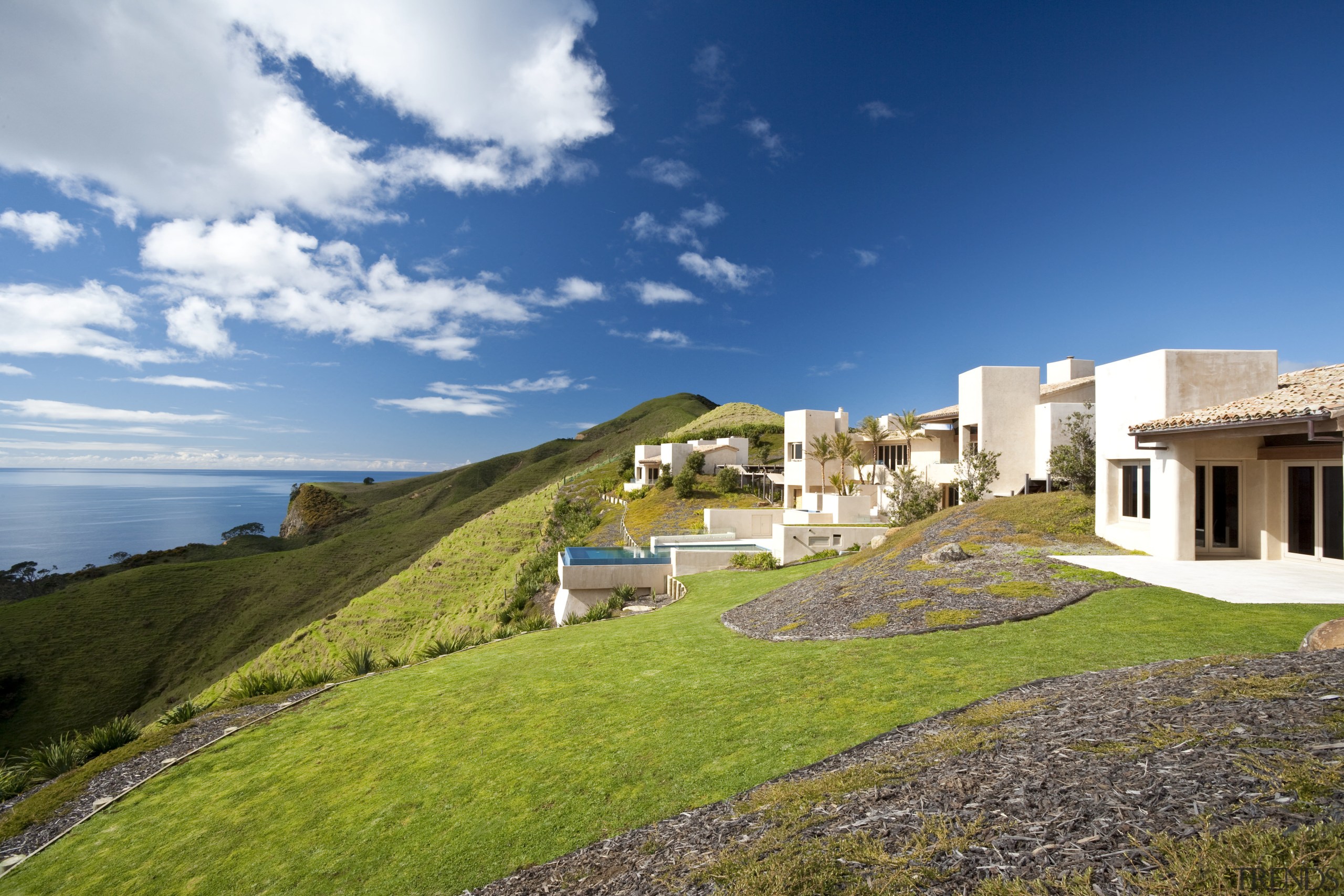 Exterior view of Mediterranean styled house which is architecture, cloud, coast, cottage, estate, grass, home, horizon, house, property, real estate, residential area, sea, sky, terrain, villa