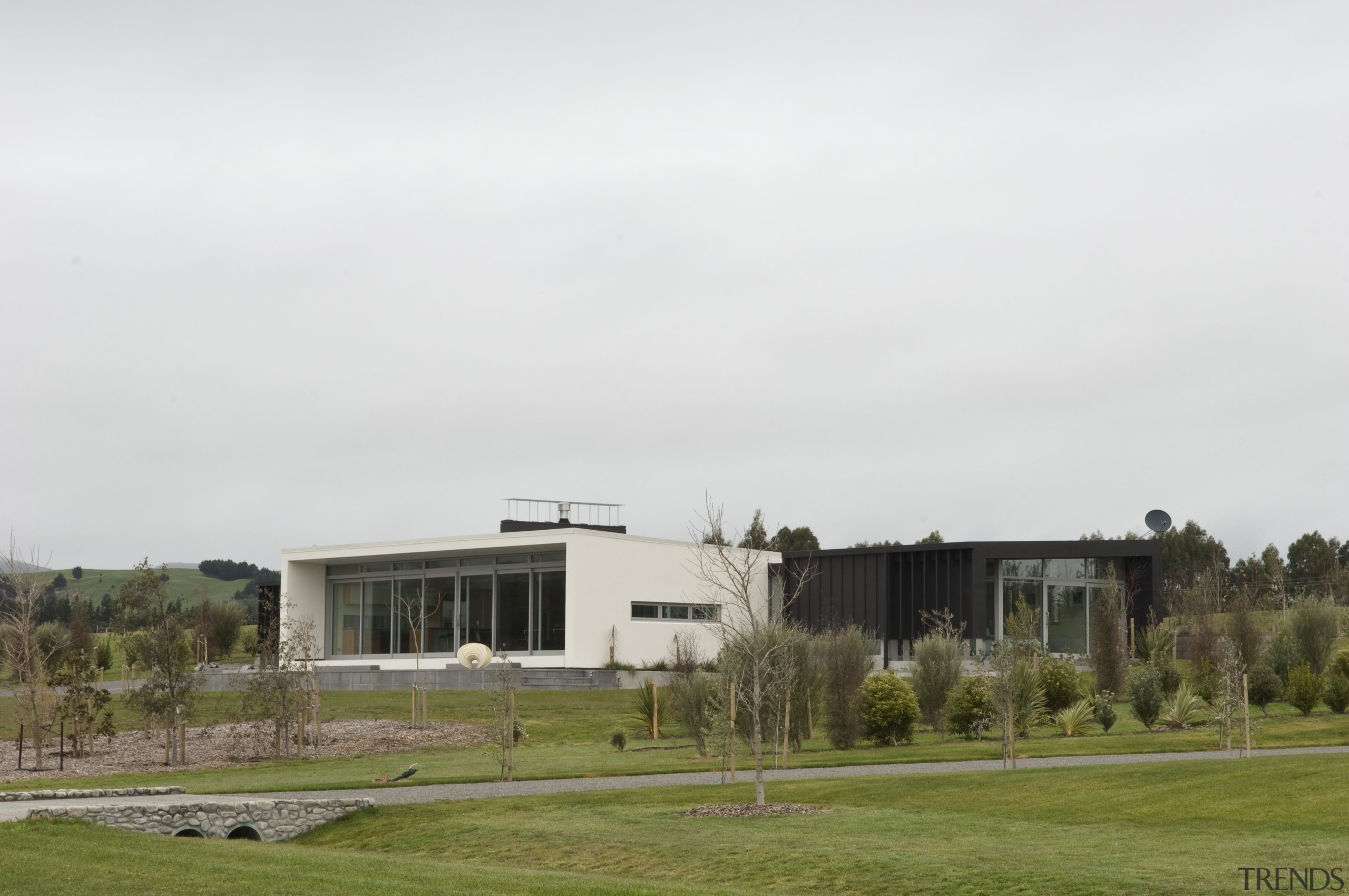 View of contemporary bach with terrace, sheltered courtyard architecture, campus, corporate headquarters, grass, home, house, real estate, sky, white