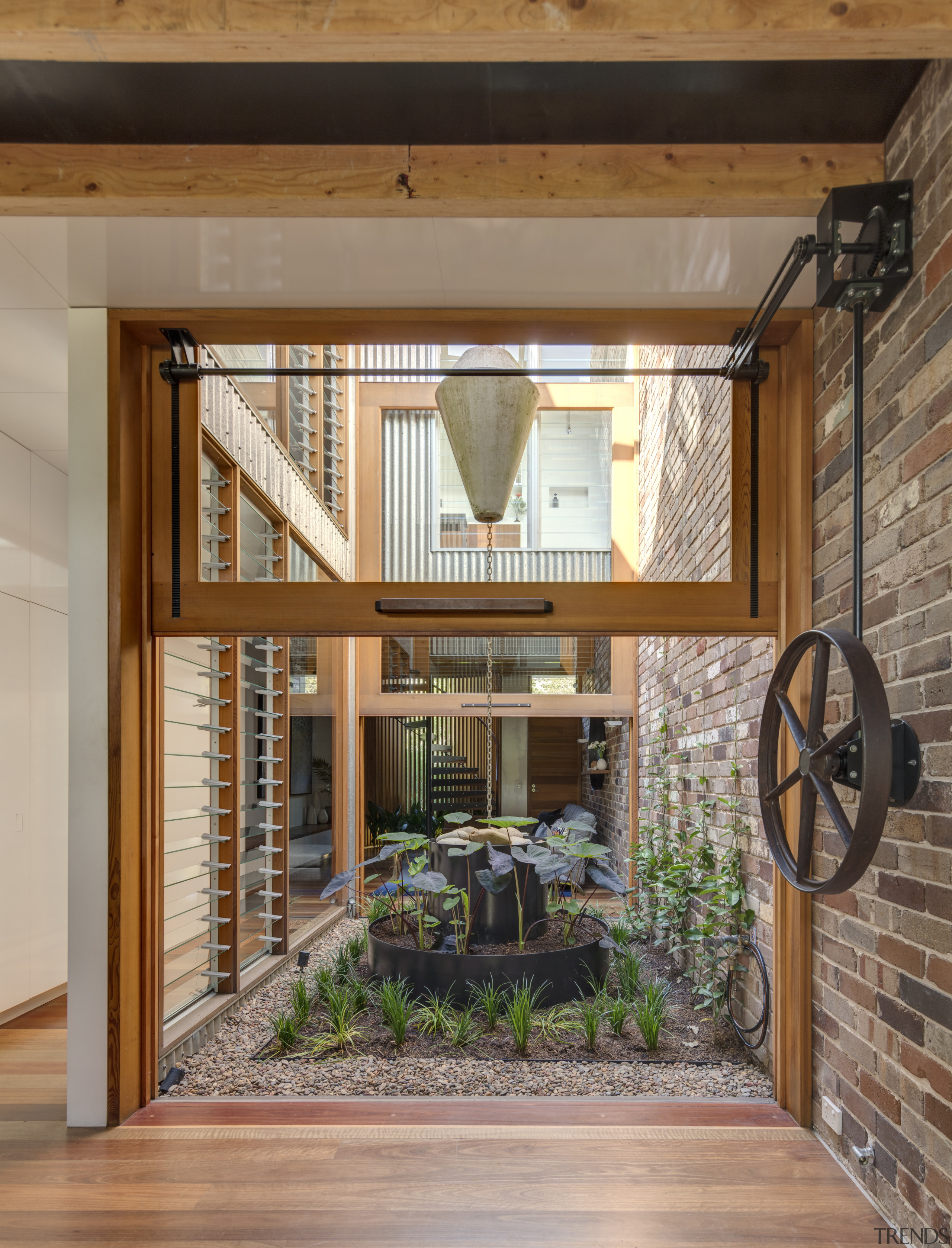 The central courtyard is accessed through vertically hung beam, home, house, interior design, real estate, window, brown, gray