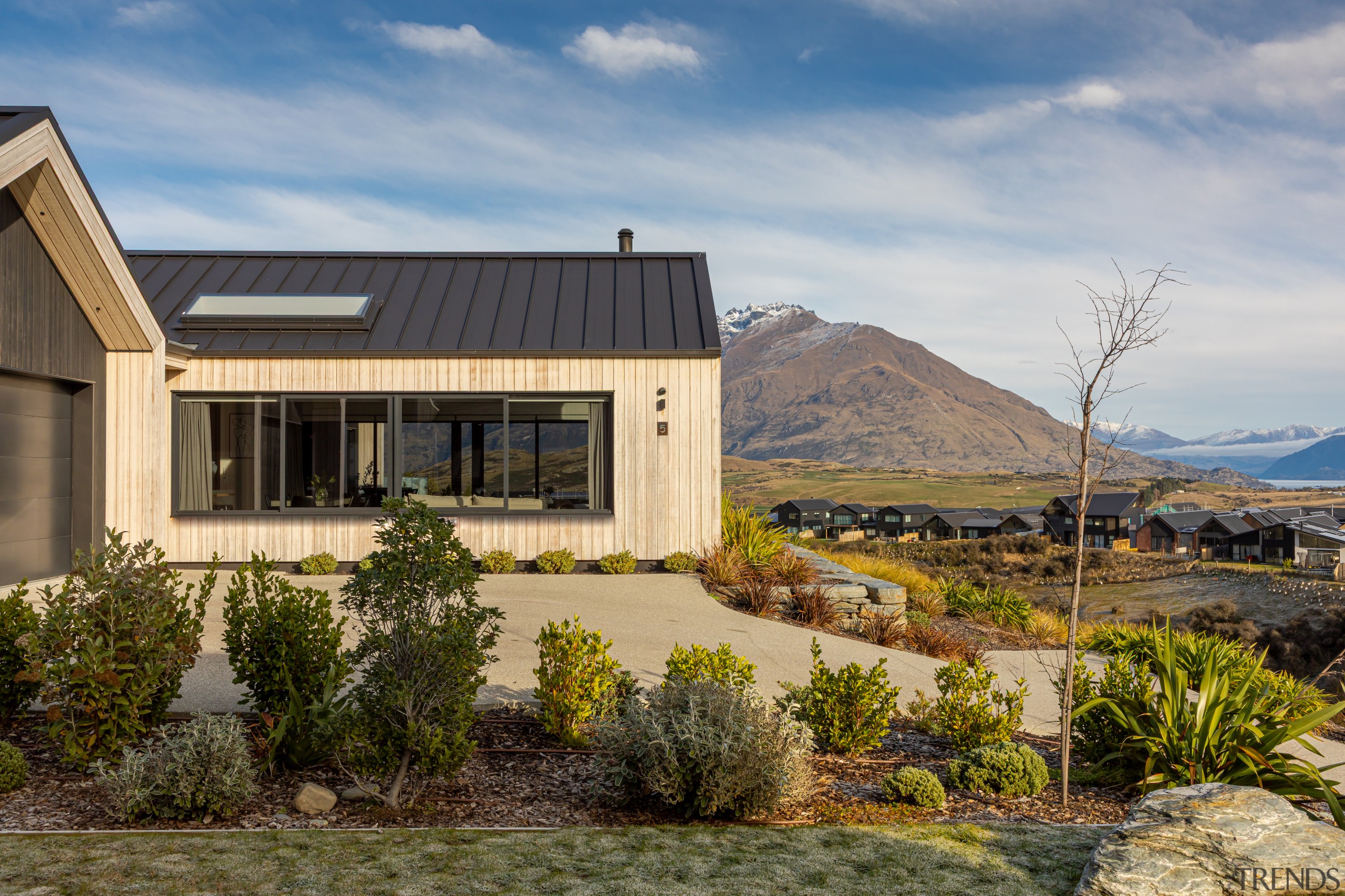 Front approach with generous drive and low-up-keep plantings. 