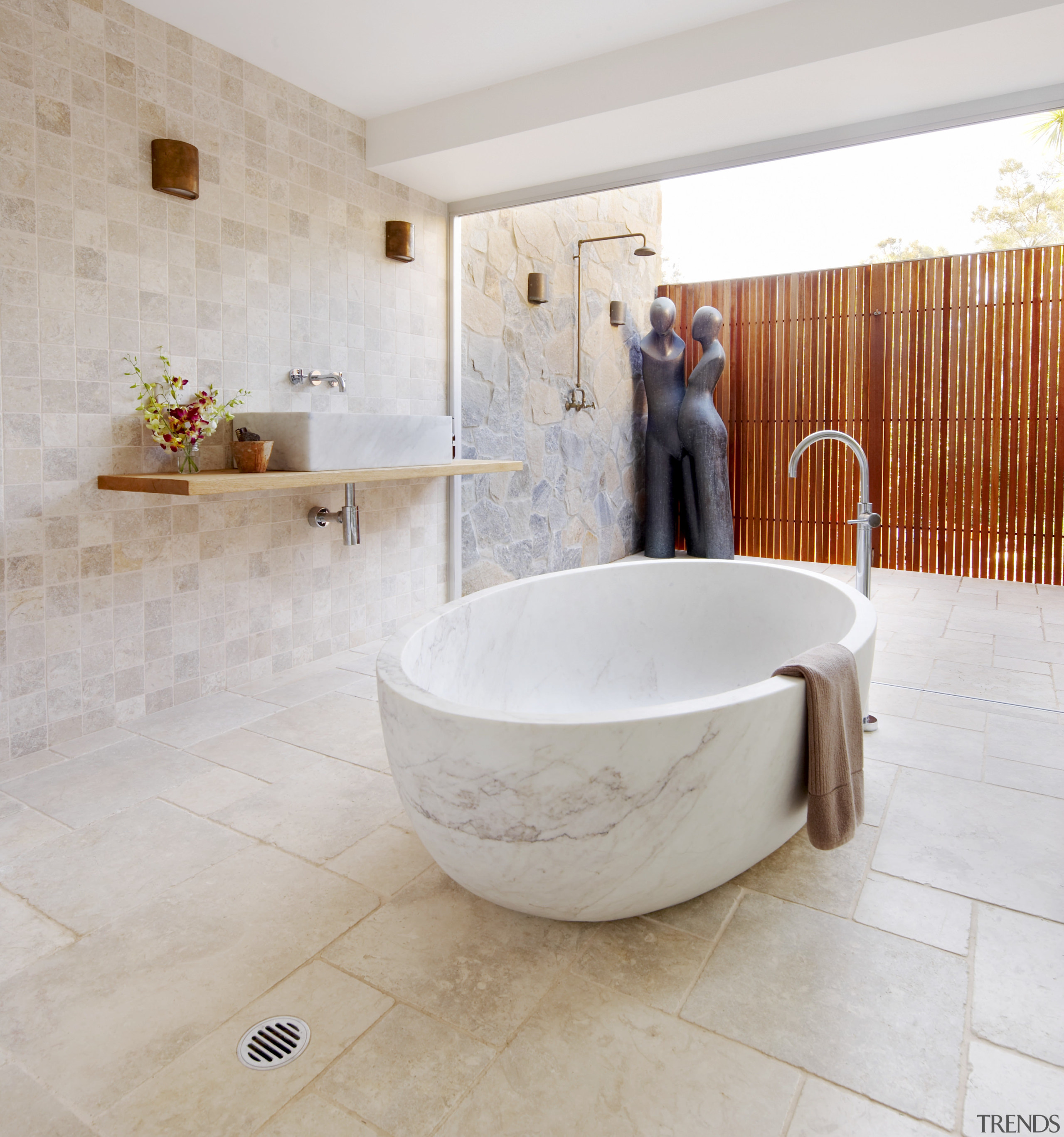 Limestone walls and floors and a wooden shelf bathroom, bathtub, ceramic, floor, flooring, interior design, plumbing fixture, product design, property, room, tap, tile, wall, gray