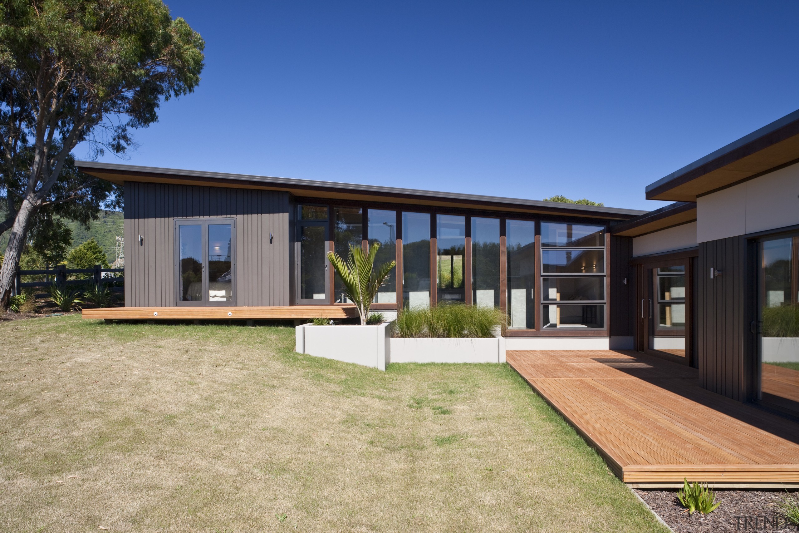 Exterior view of a energy-efficient home which natural architecture, backyard, cottage, estate, facade, farmhouse, home, house, property, real estate, residential area, roof, siding, yard