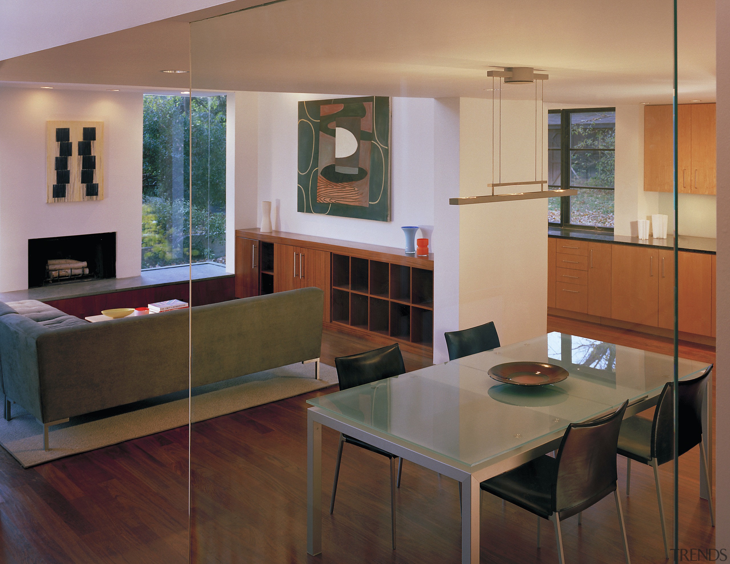 A lowered ceiling above the dining area demarcates architecture, furniture, interior design, living room, real estate, room, table, brown