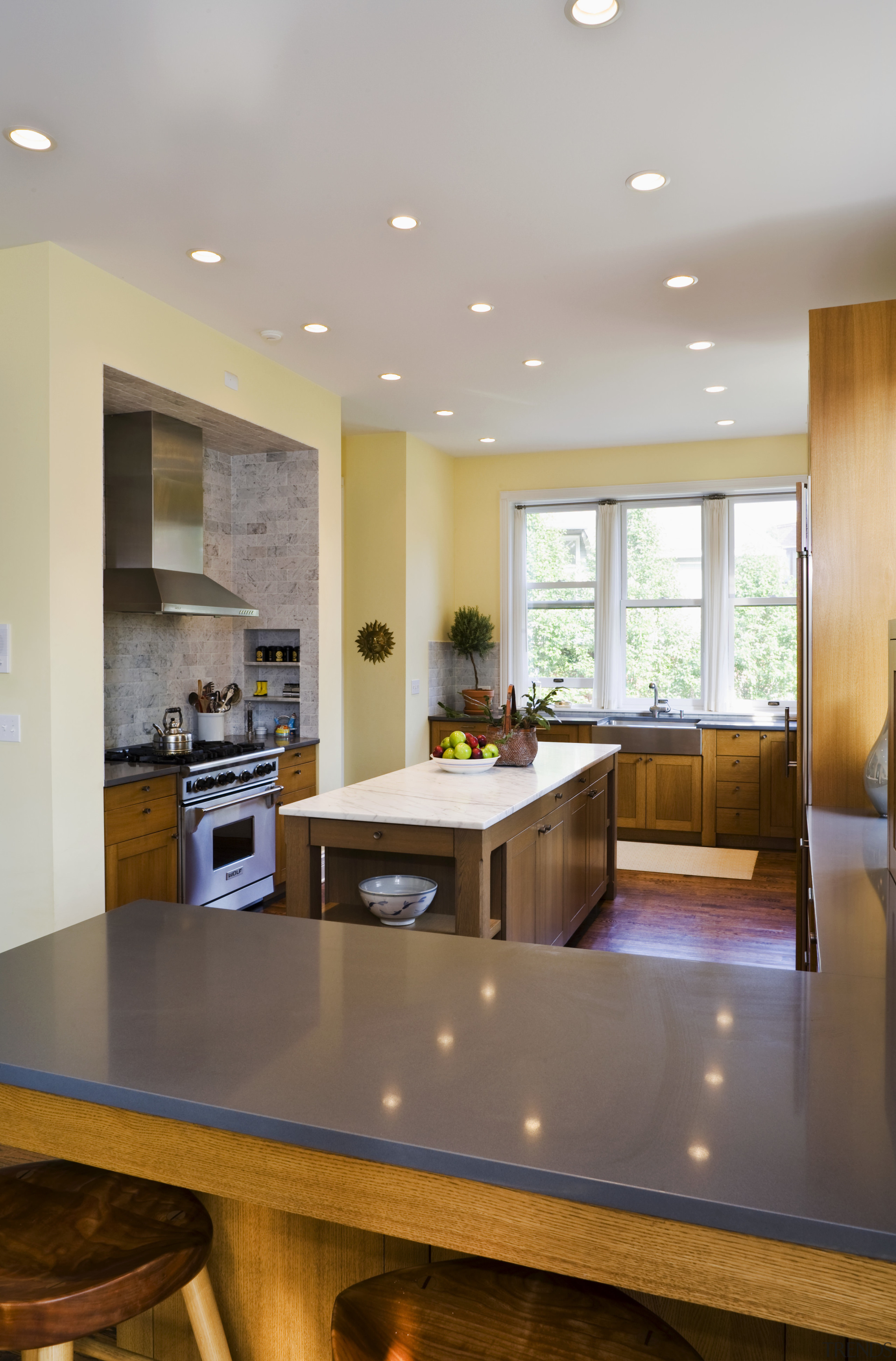 A view of the kitchen area showing the cabinetry, ceiling, countertop, floor, flooring, hardwood, home, interior design, kitchen, living room, real estate, room, wood flooring, gray, brown