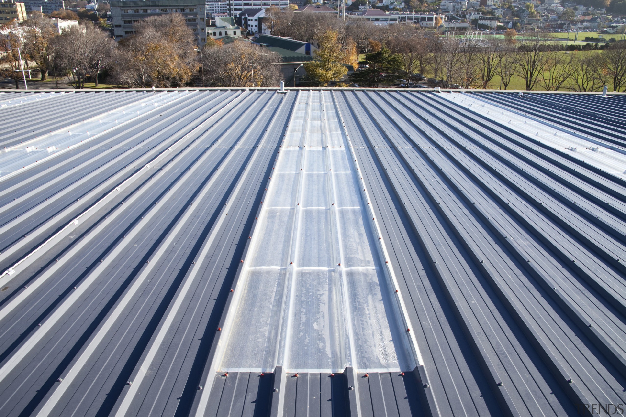 View of grey roof. - View of grey architecture, asphalt, daylighting, daytime, line, outdoor structure, roof, sky, solar panel, solar power, gray