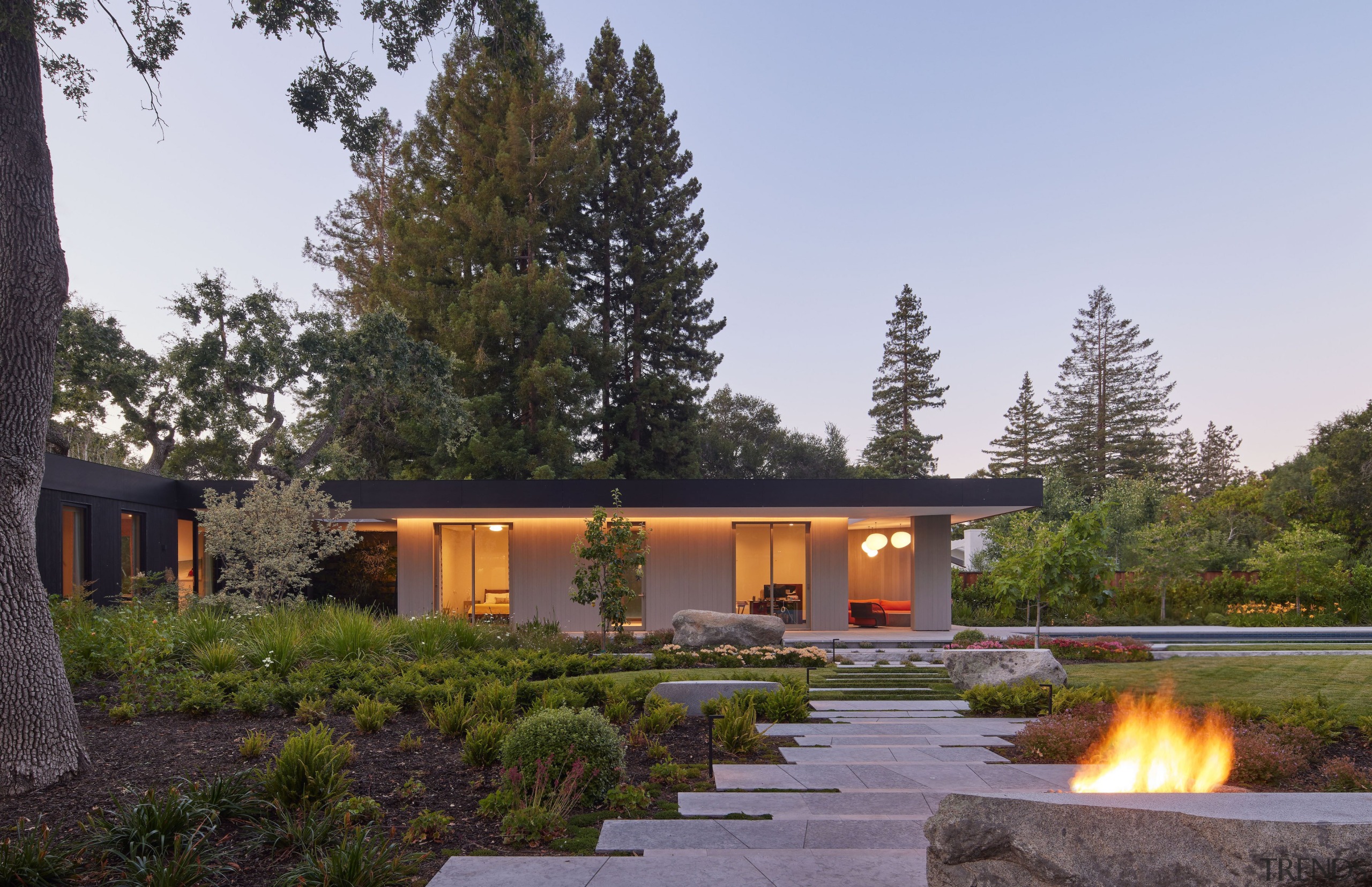 Fire pit and master bedroom wing at rear. 