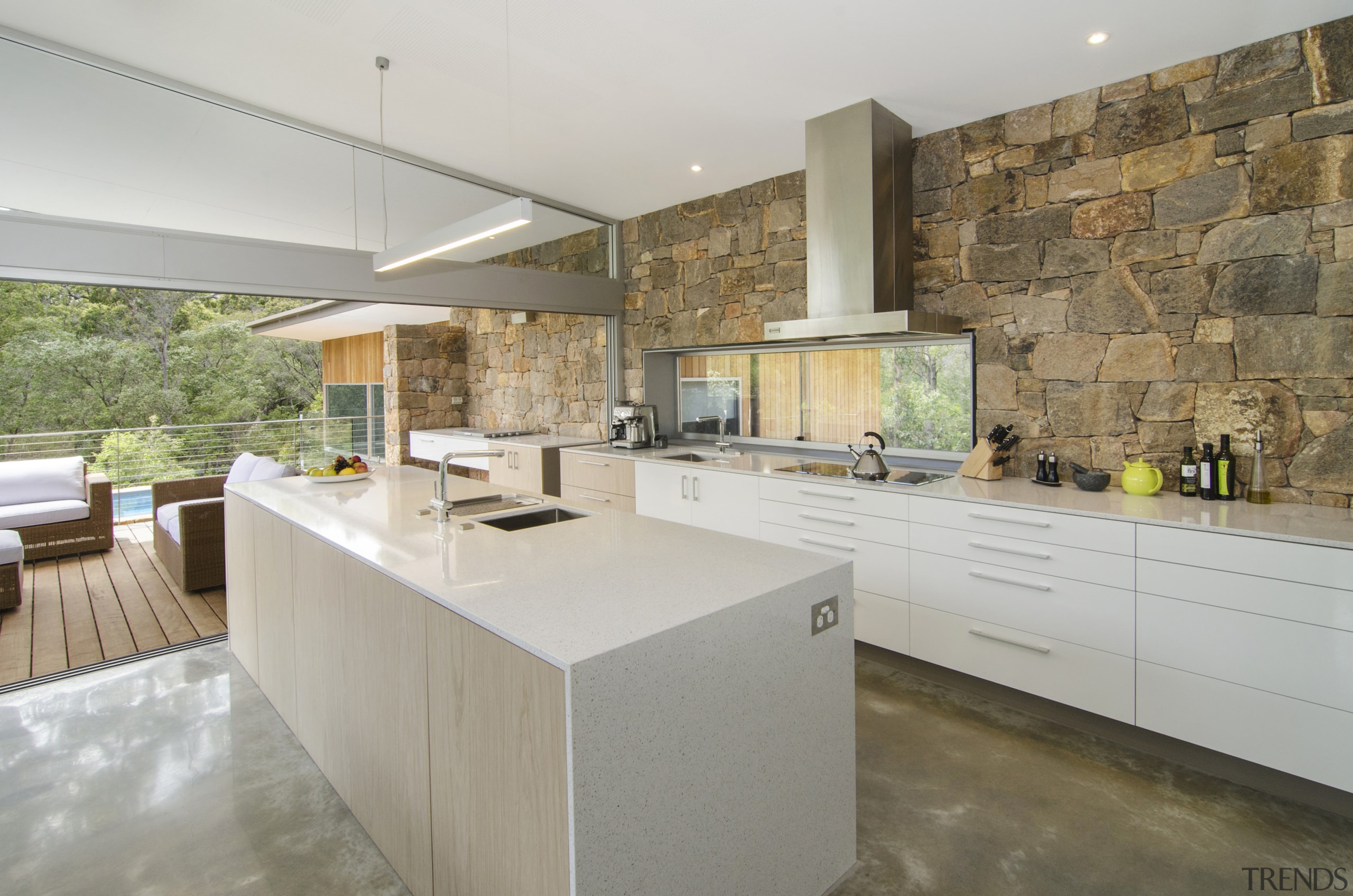 An absence of overhead cabinets ensures the stone architecture, countertop, estate, floor, flooring, house, interior design, kitchen, real estate, wood flooring, gray