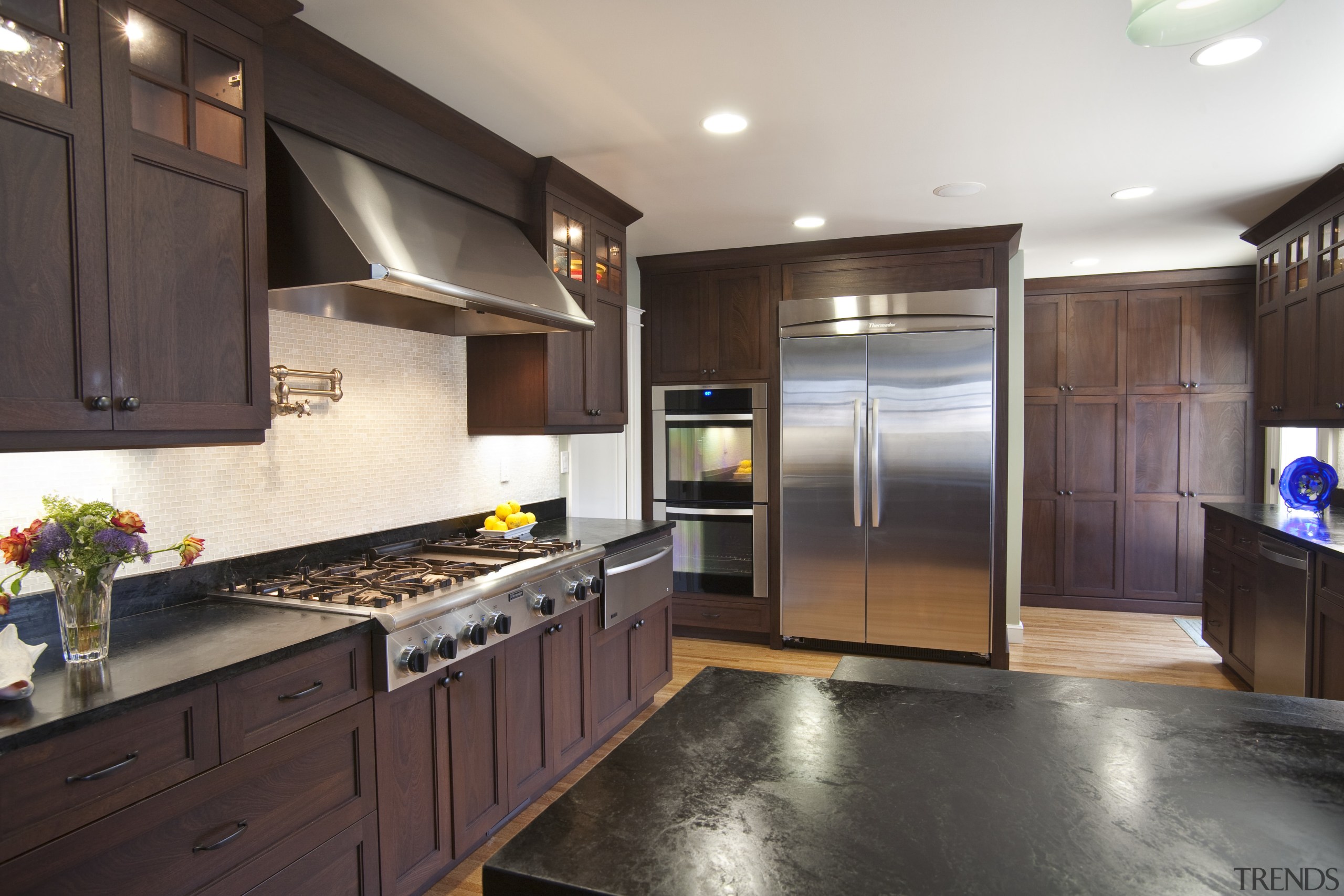 View of a traditional-styled kitchen designed by Pacific cabinetry, countertop, cuisine classique, interior design, kitchen, real estate, room, black, white