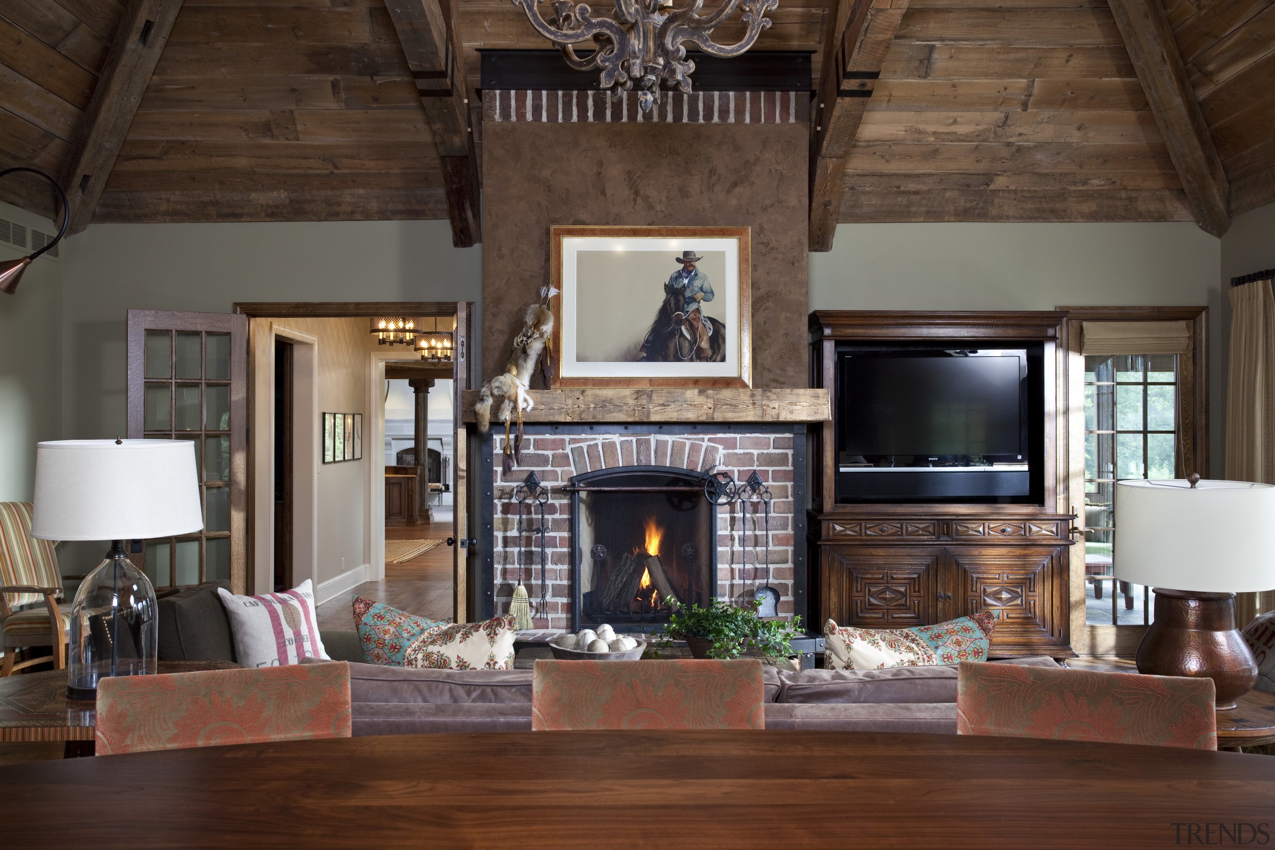 Exposed wood beams with metal strapping enhance the ceiling, fireplace, hardwood, hearth, home, interior design, living room, real estate, room, wood, brown