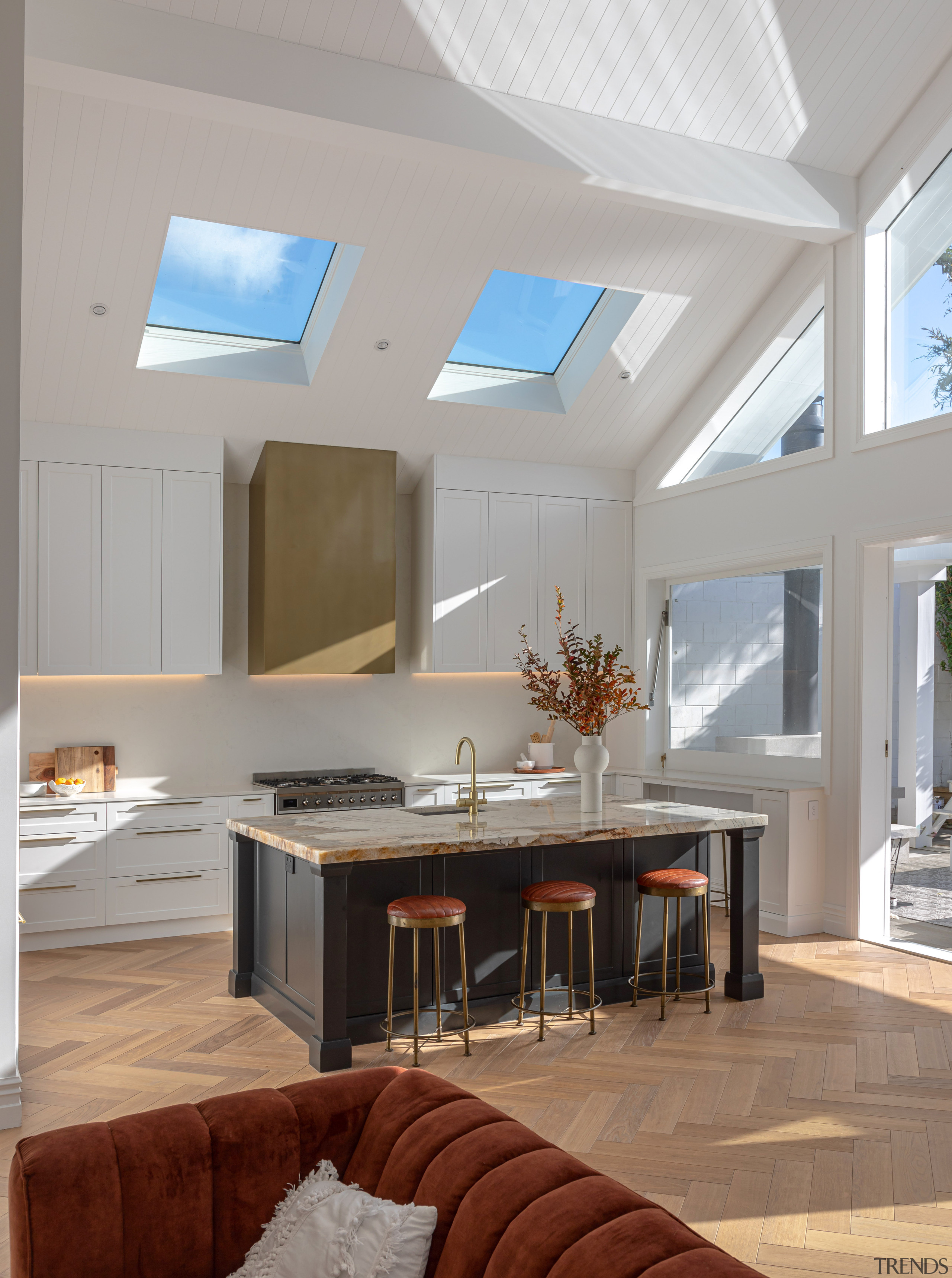 Kitchen with soaring ceiling and skylights above. 