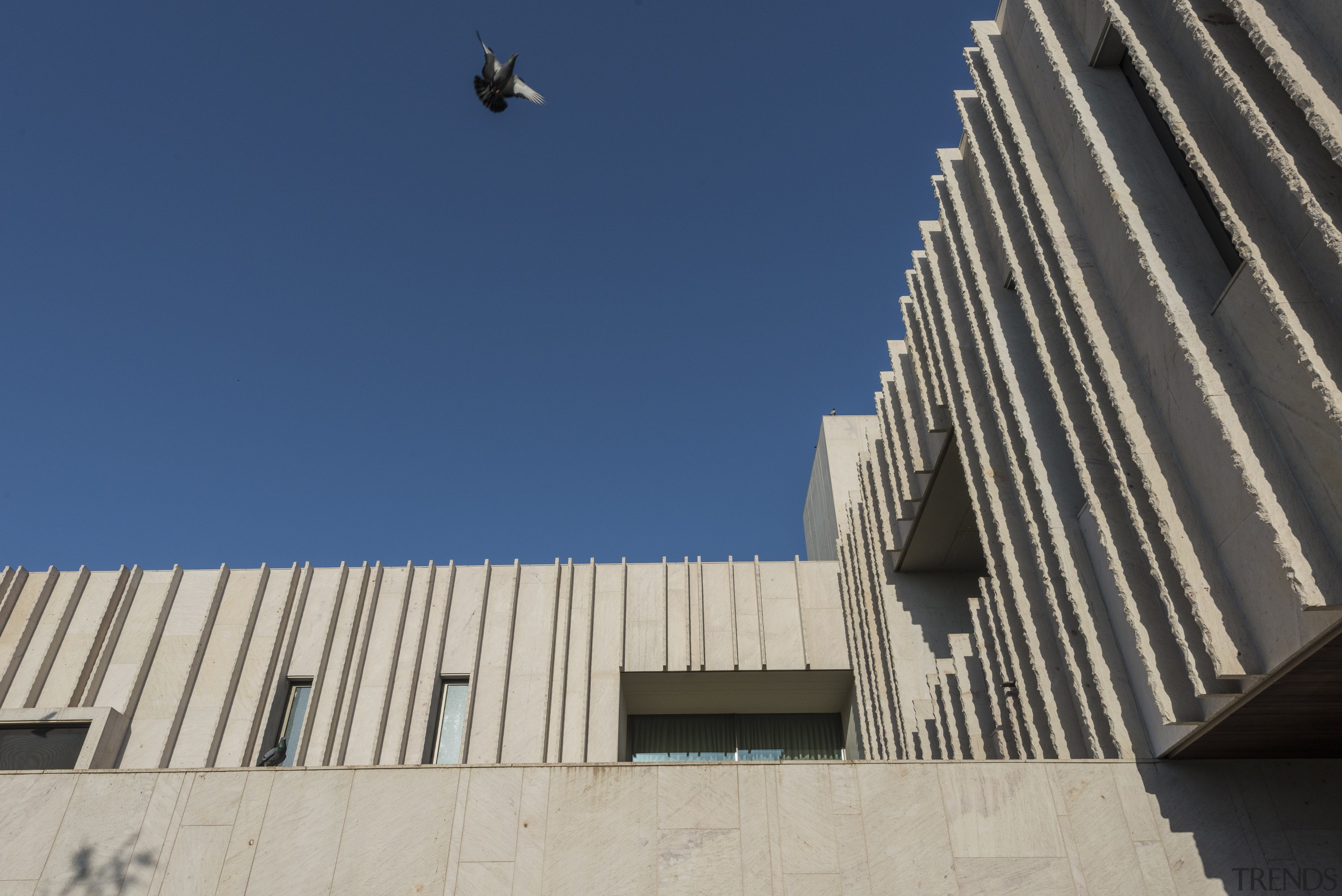 With sandstone plentiful in Ahmedabad, India, it was architecture, brutalist architecture, building, city, daytime, facade, line, reinforced concrete, sky, urban area, blue, gray