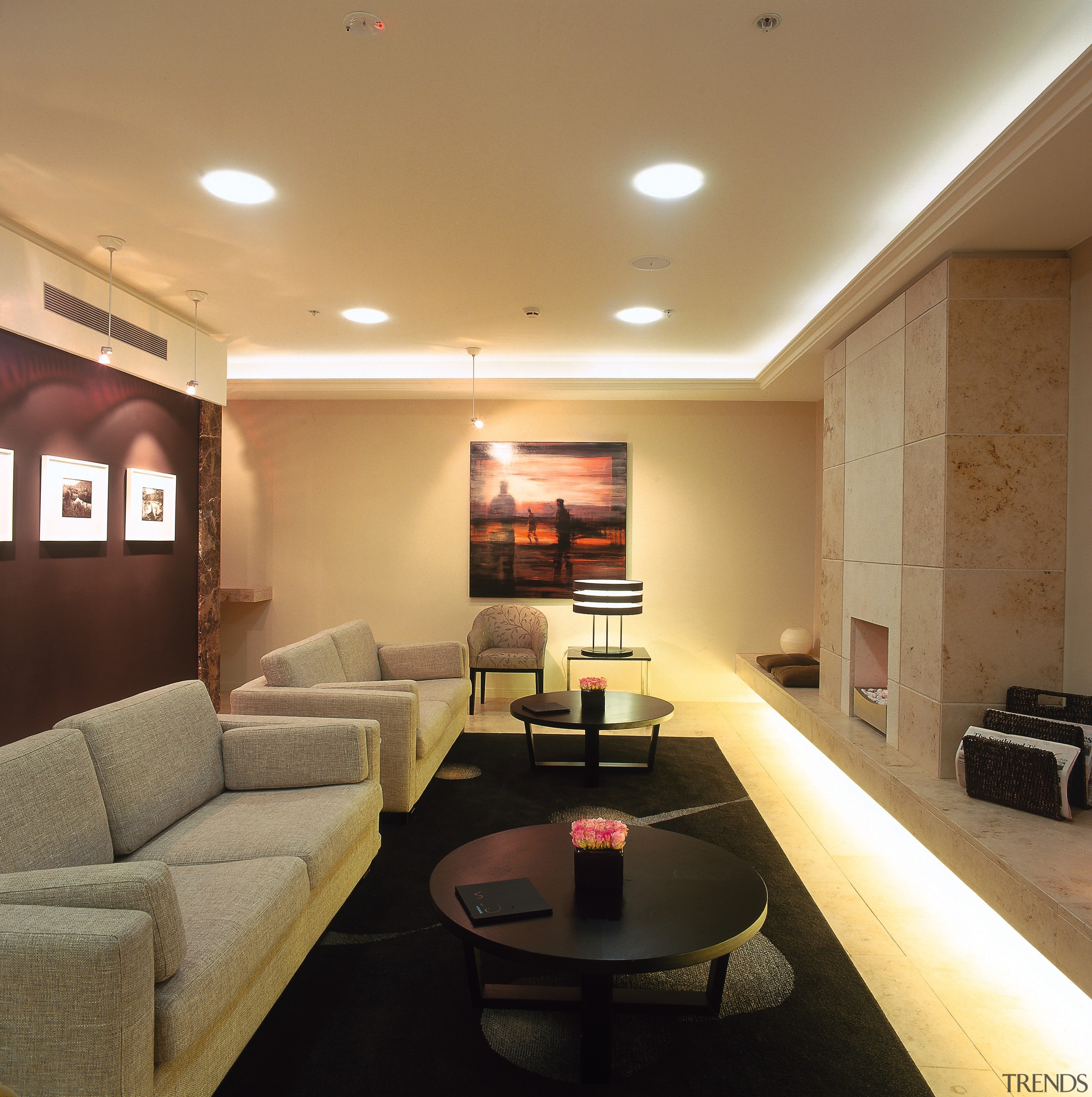 A view of the business lounge. - A ceiling, floor, interior design, lighting, living room, lobby, real estate, room, wall, brown, orange