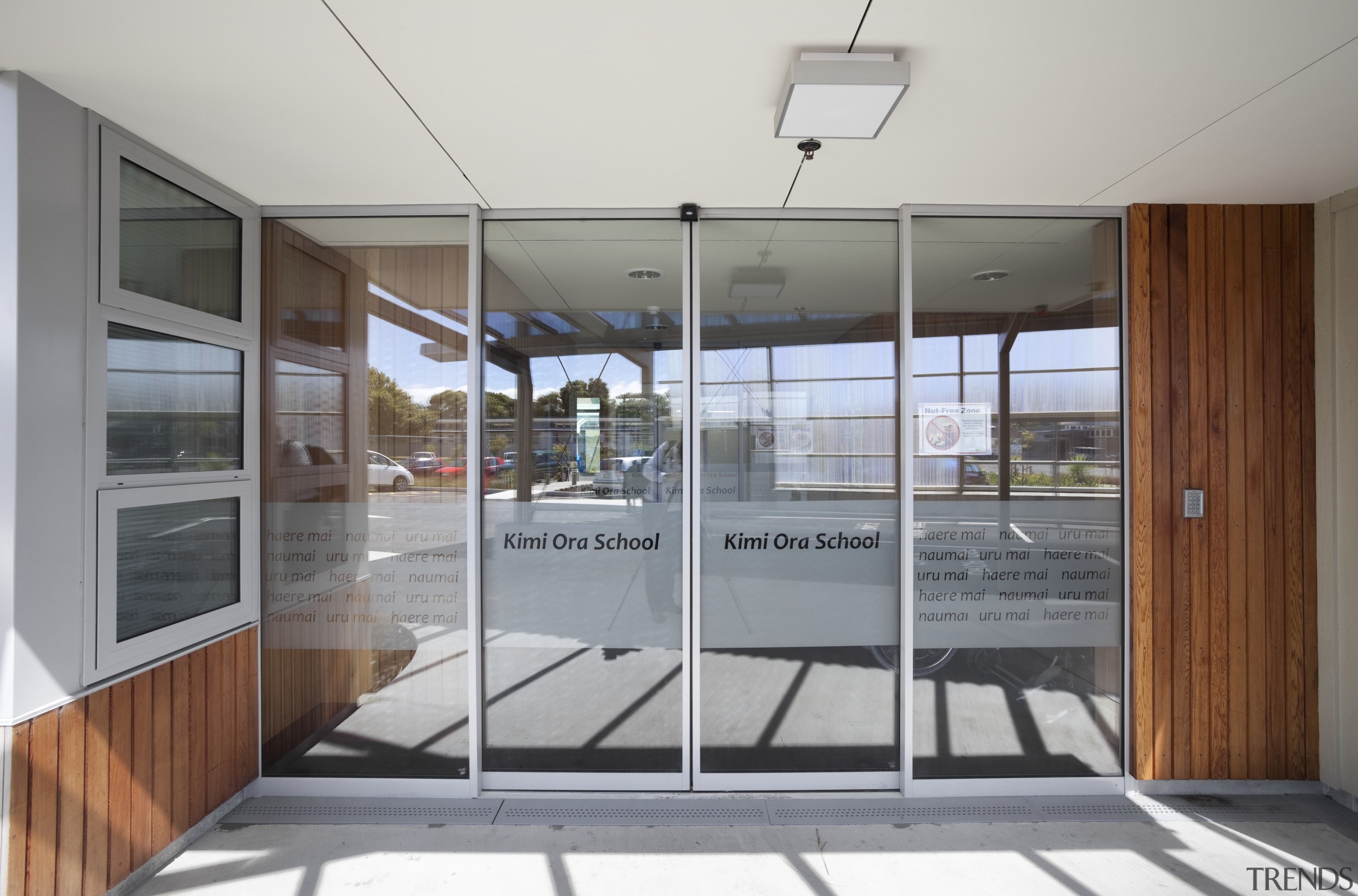 View of doorway to school. - View of architecture, door, glass, house, real estate, window, gray