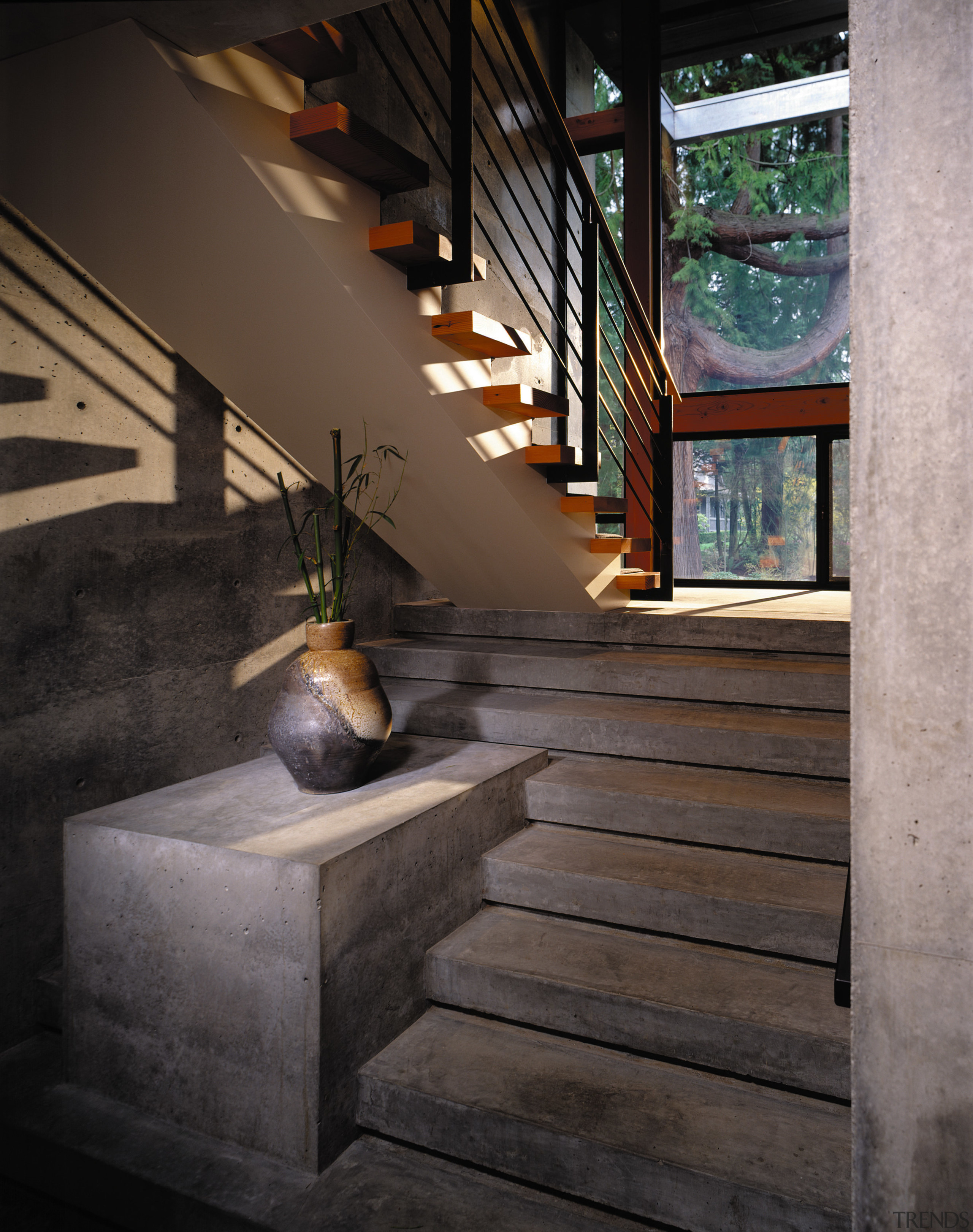 View of concrete stairway looking out into the architecture, glass, handrail, interior design, stairs, wood, black, gray