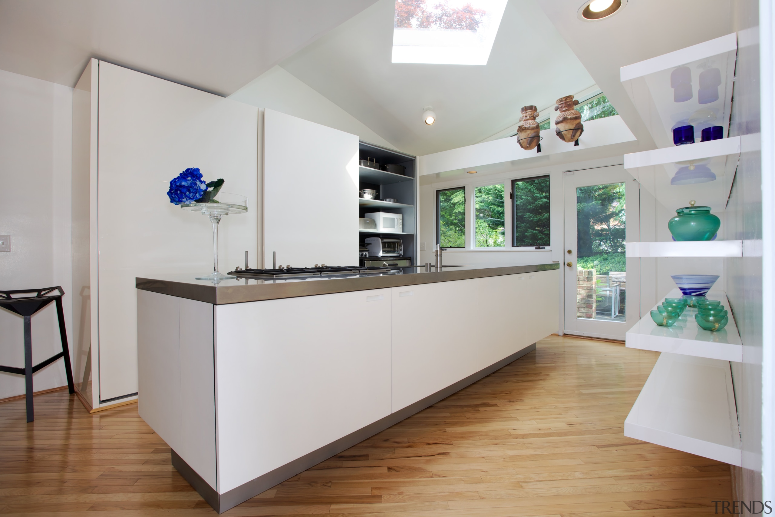 Appliances are concealed in this minimalist galley kitchen interior design, kitchen, real estate, gray