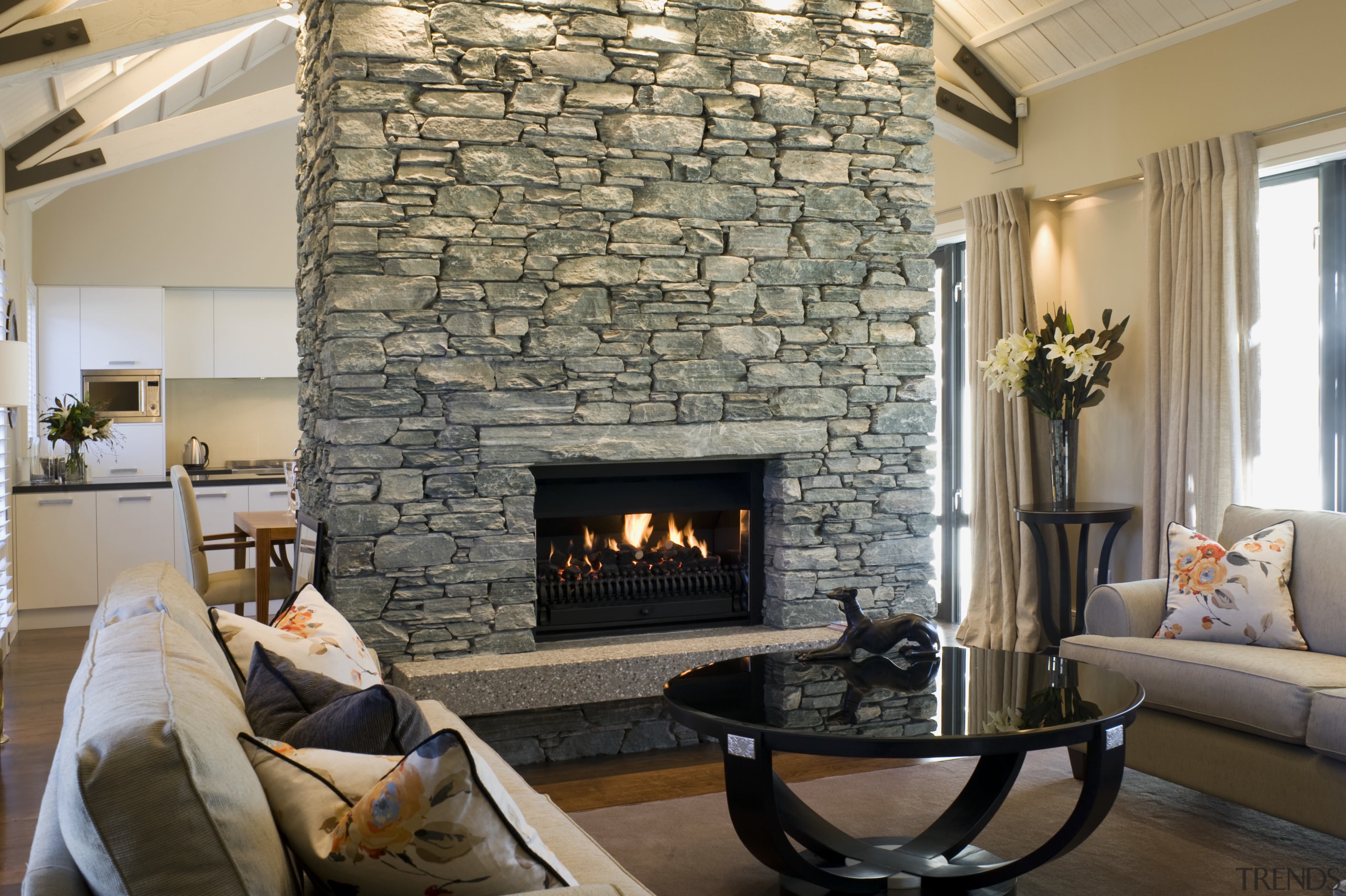 The central schist fireplace is left unadorned, as fireplace, hearth, home, interior design, living room, room, gray
