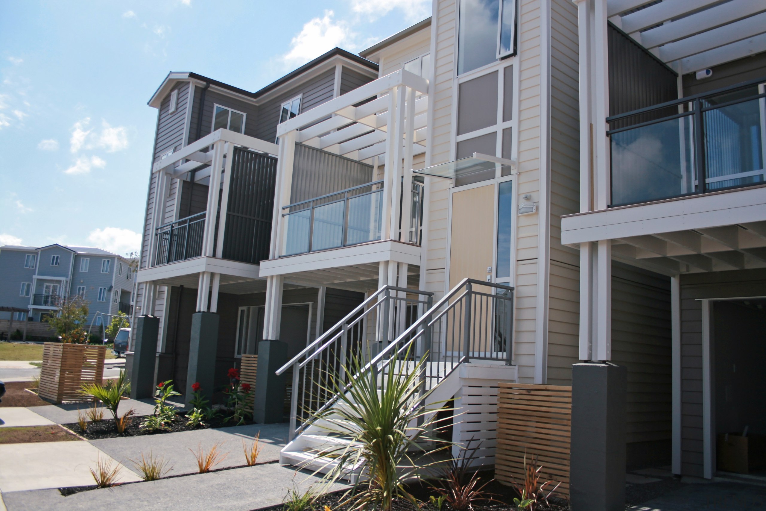 Finished homes with the different balustrades on the apartment, building, condominium, elevation, facade, home, house, mixed use, neighbourhood, property, real estate, residential area, siding, window, gray, black