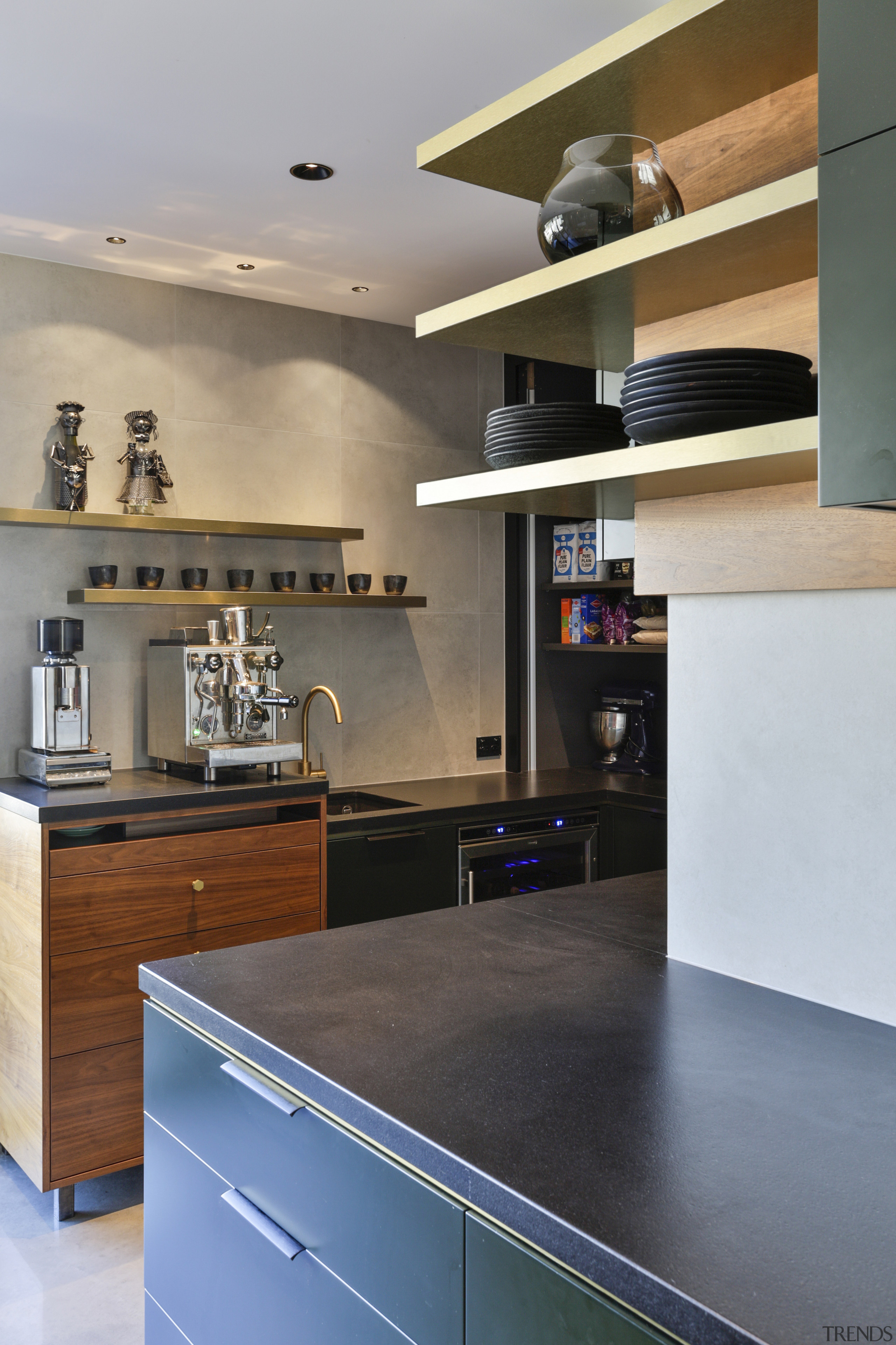 The kitchen includes a wealth of display shelving. 