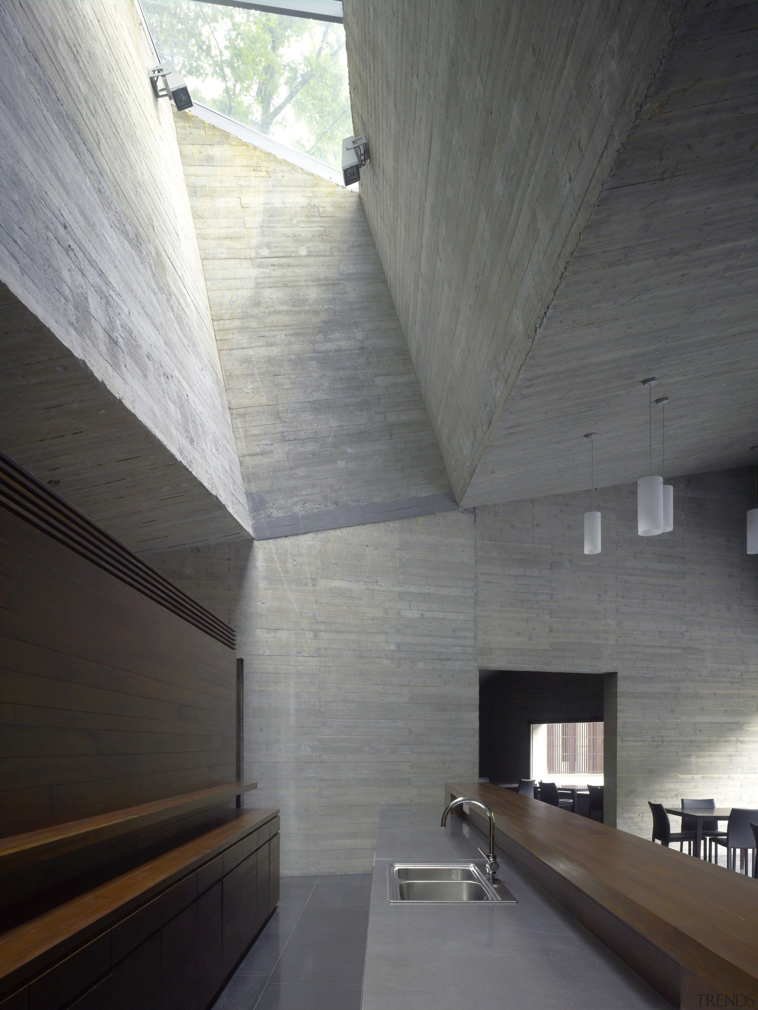 Interior view of the clubhouse which features volcanic architecture, ceiling, daylighting, daytime, floor, house, interior design, wall, wood, wood flooring, gray, black