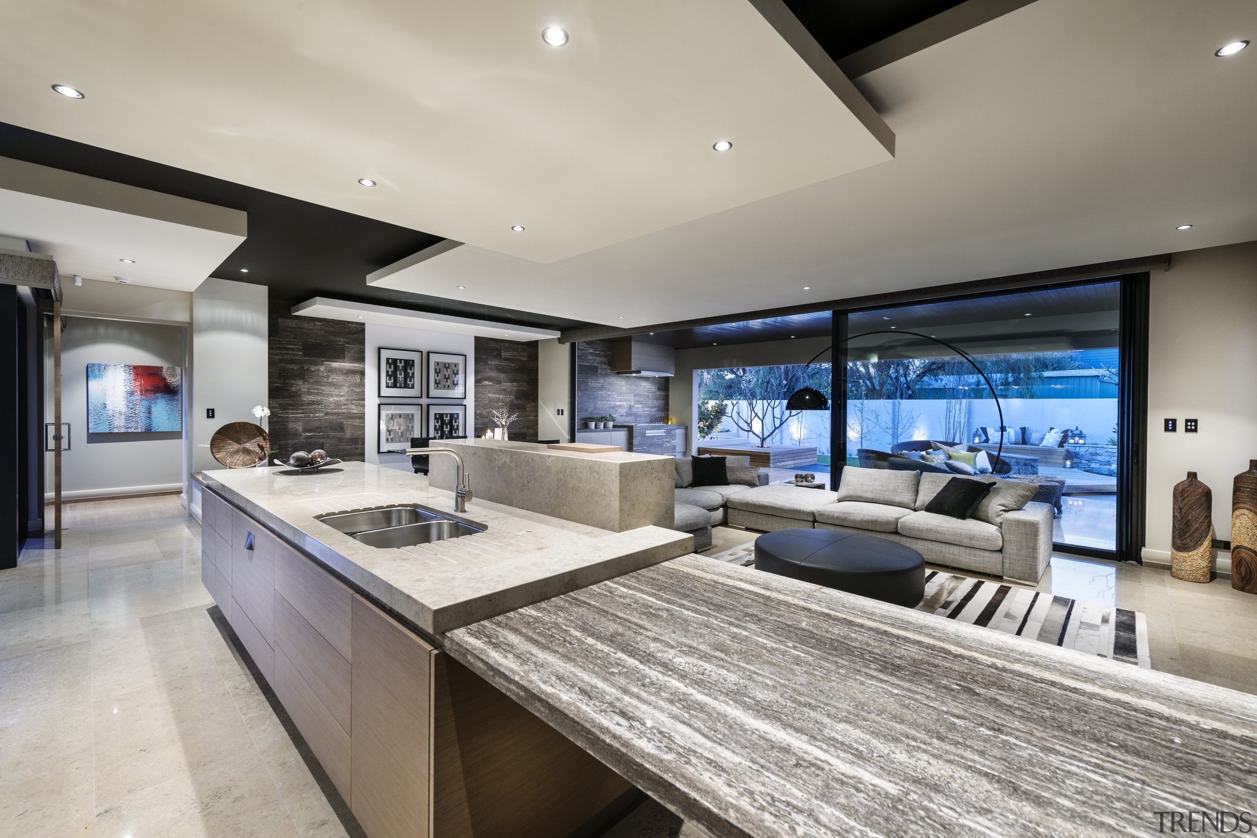 Kitchen connects with living spaces by shared palette countertop, estate, interior design, kitchen, living room, real estate, gray